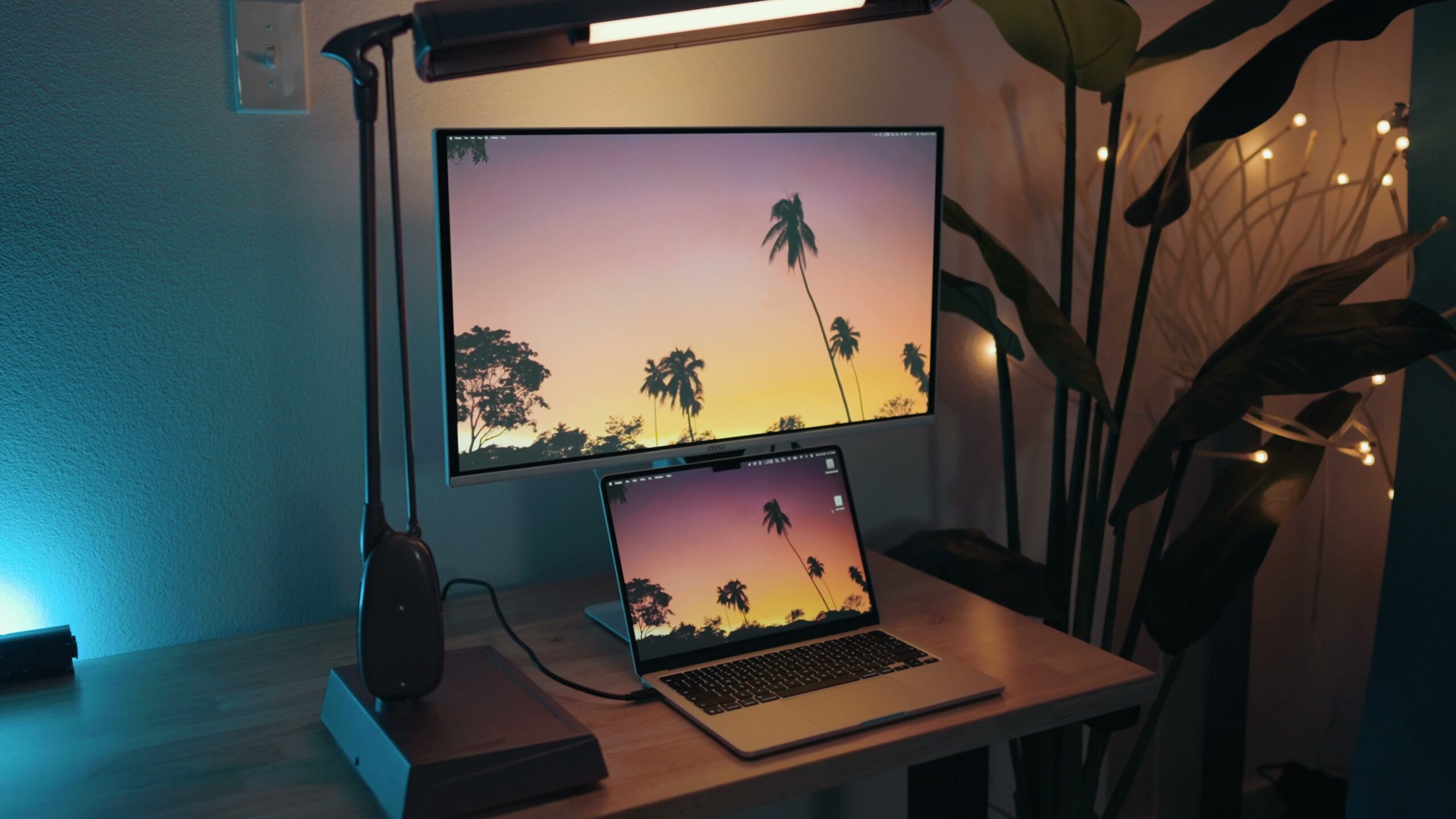 MSI Pro Max 27 in off-white sitting next to a MacBook, colors blending together