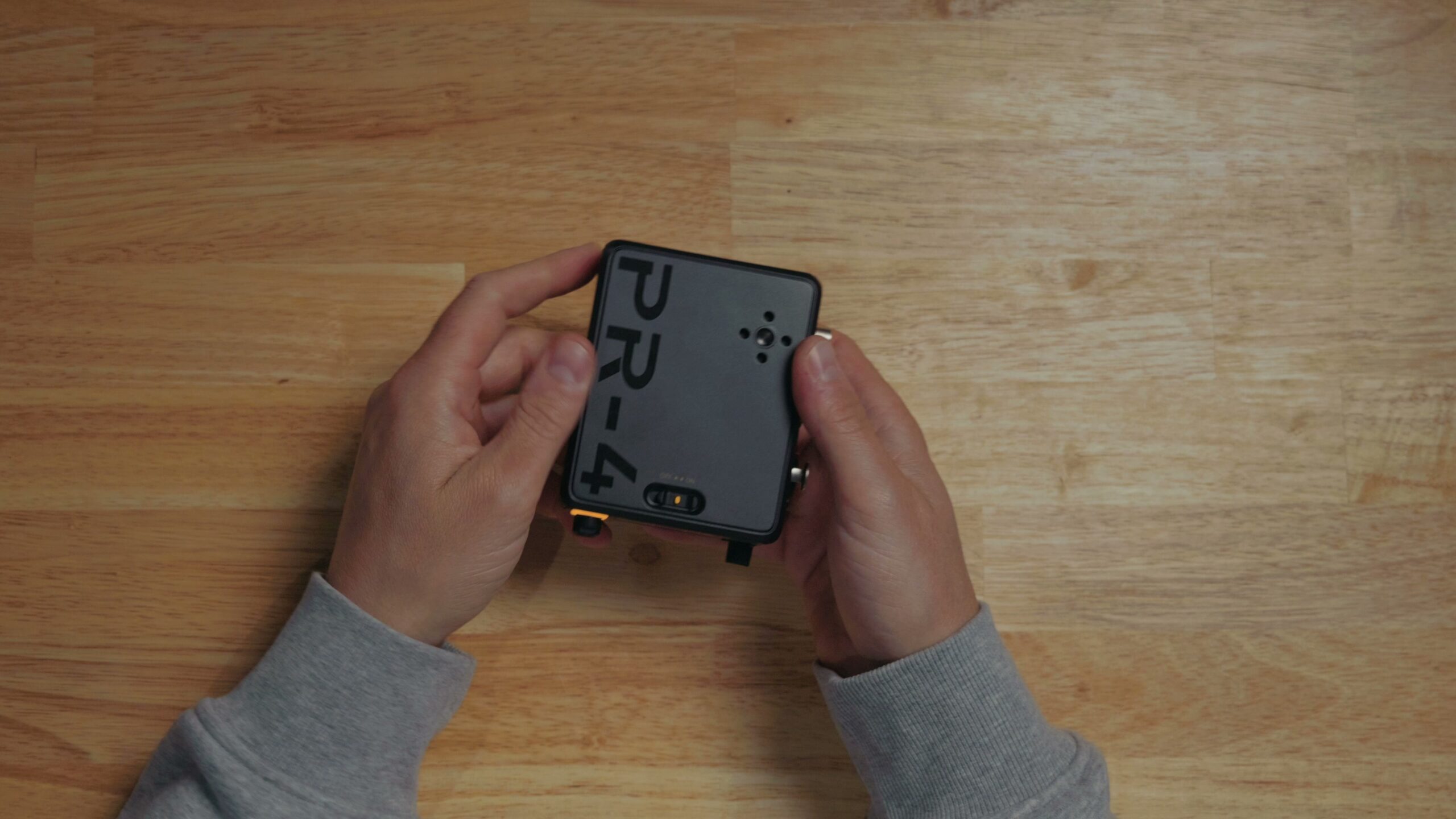 The Deity PR4 audio recorder held in a hand, showing its small size