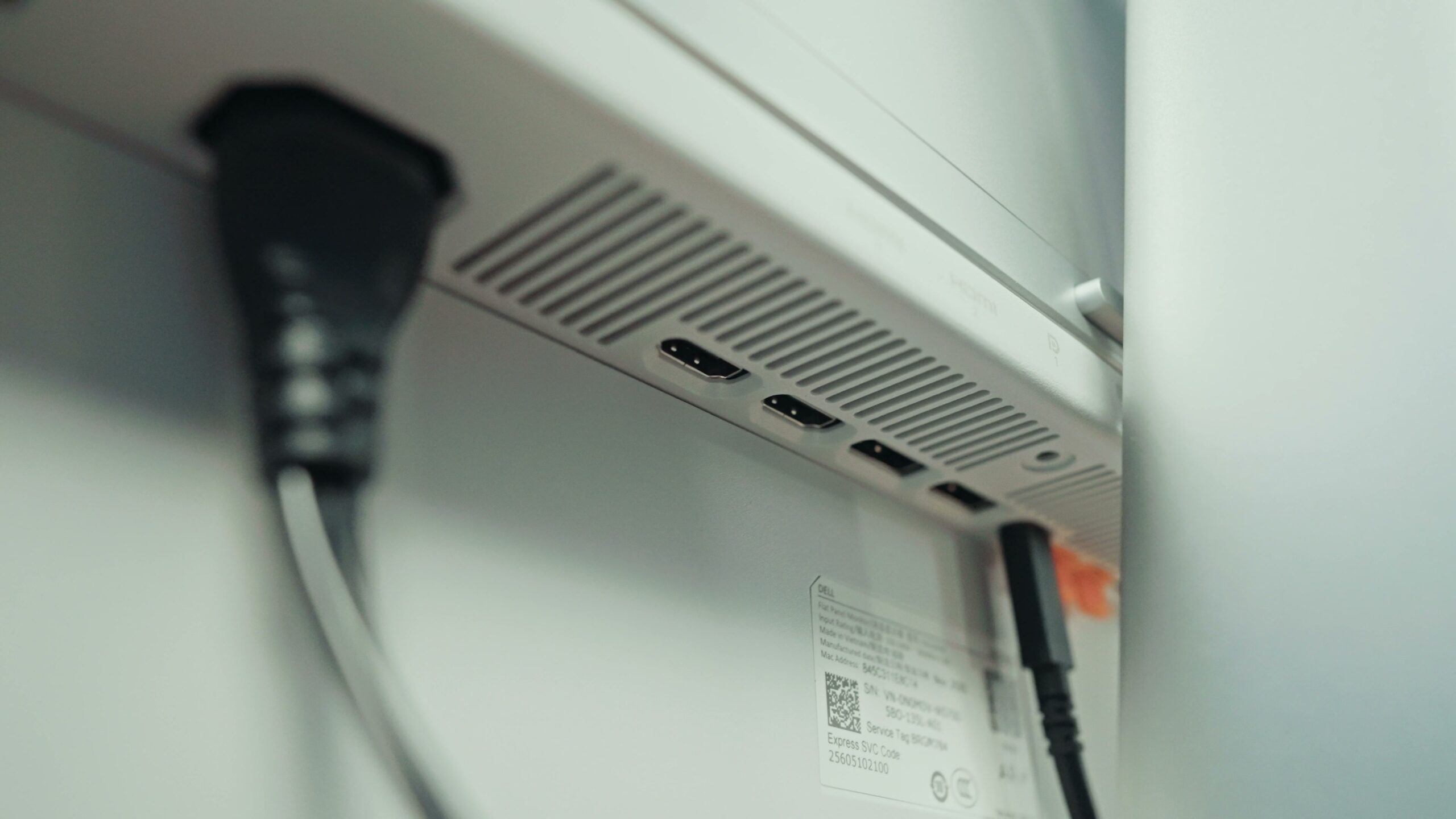 Close-up of the rear ports on the Dell monitor including HDMI, DisplayPort and USB
