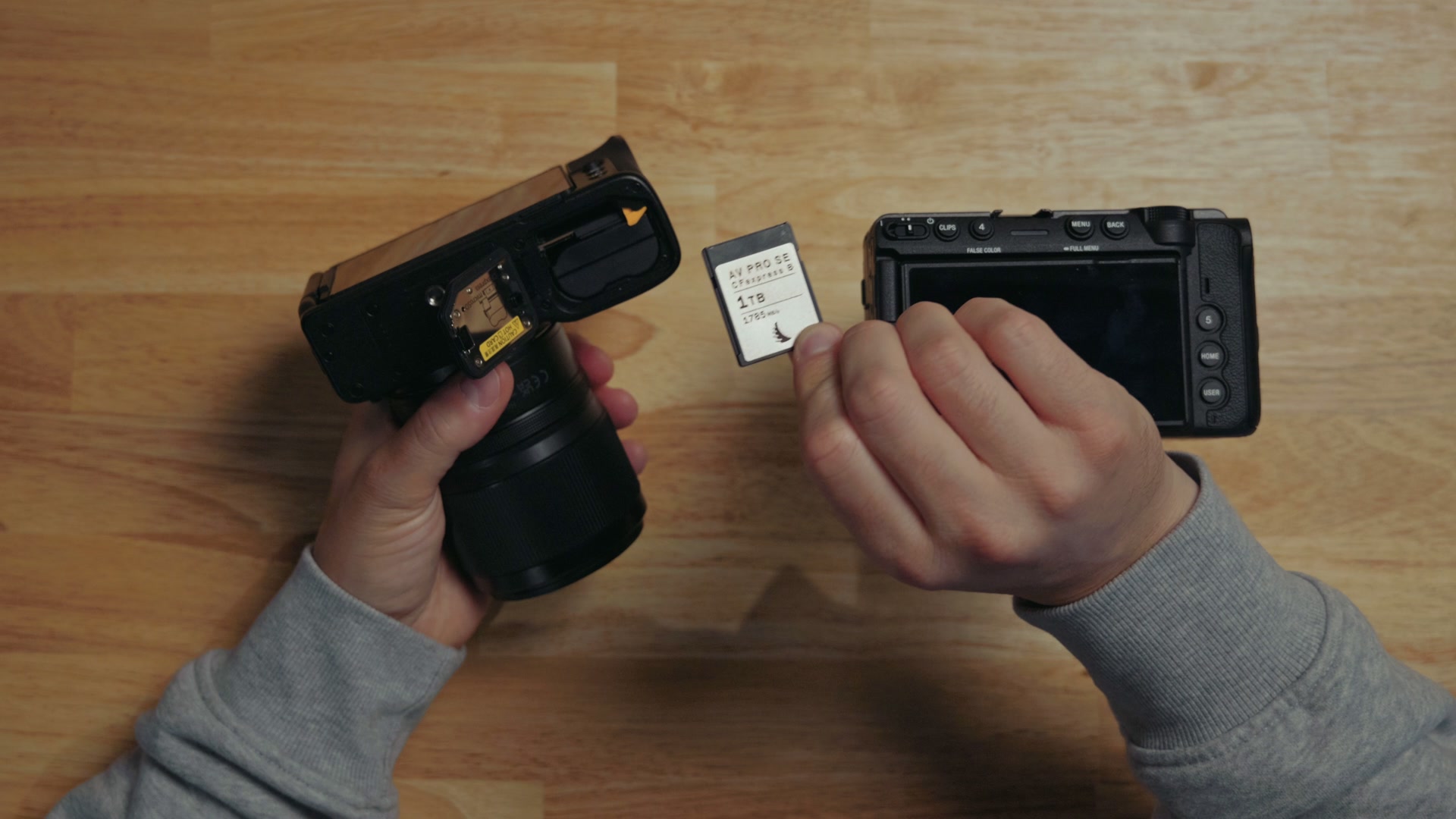 The Nikon ZR battery compartment open, showing the CFexpress Type B and microSD card slots next to the battery