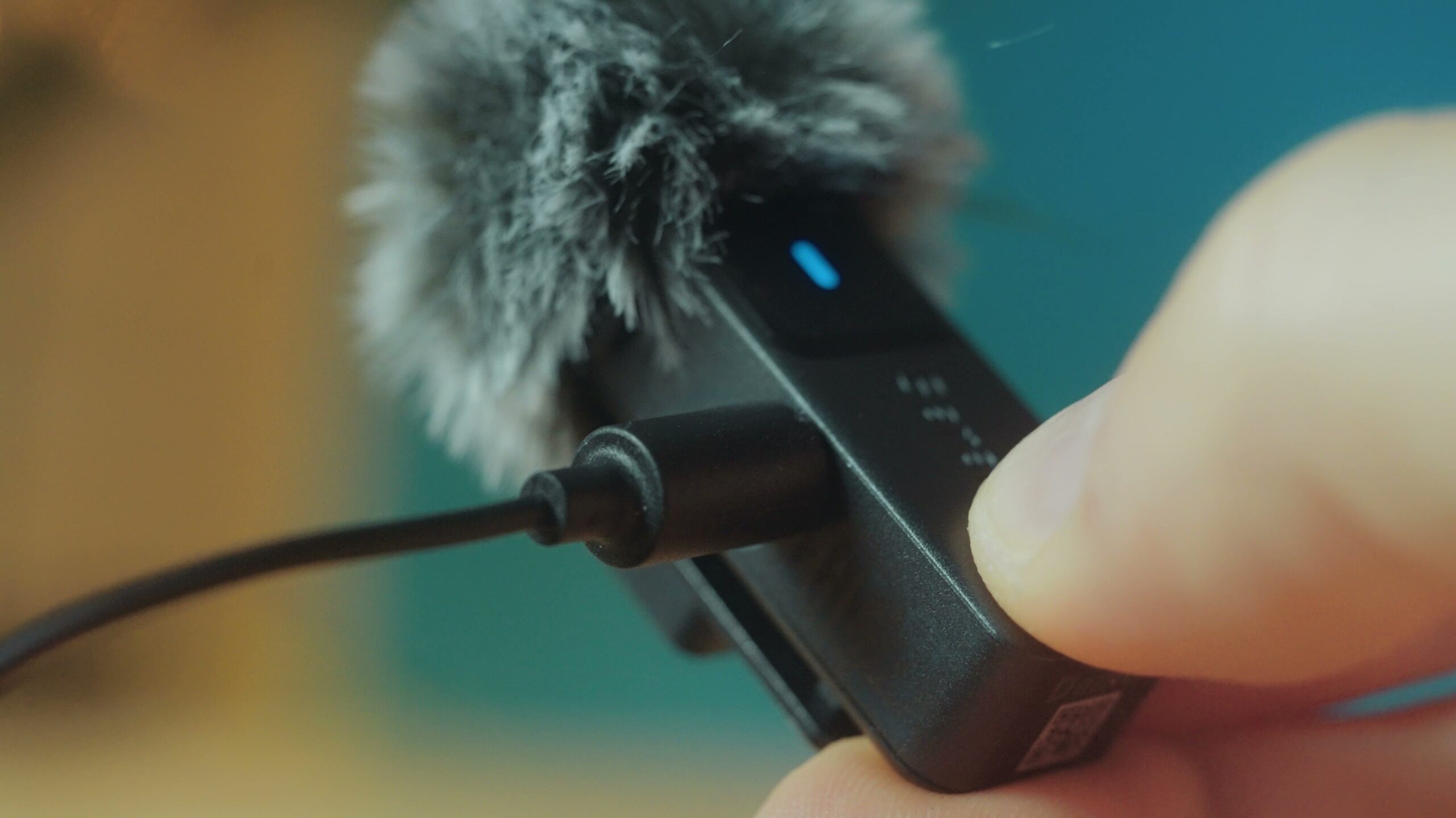Lav mic connecting to the small input on the side of a Saramonic Air transmitter