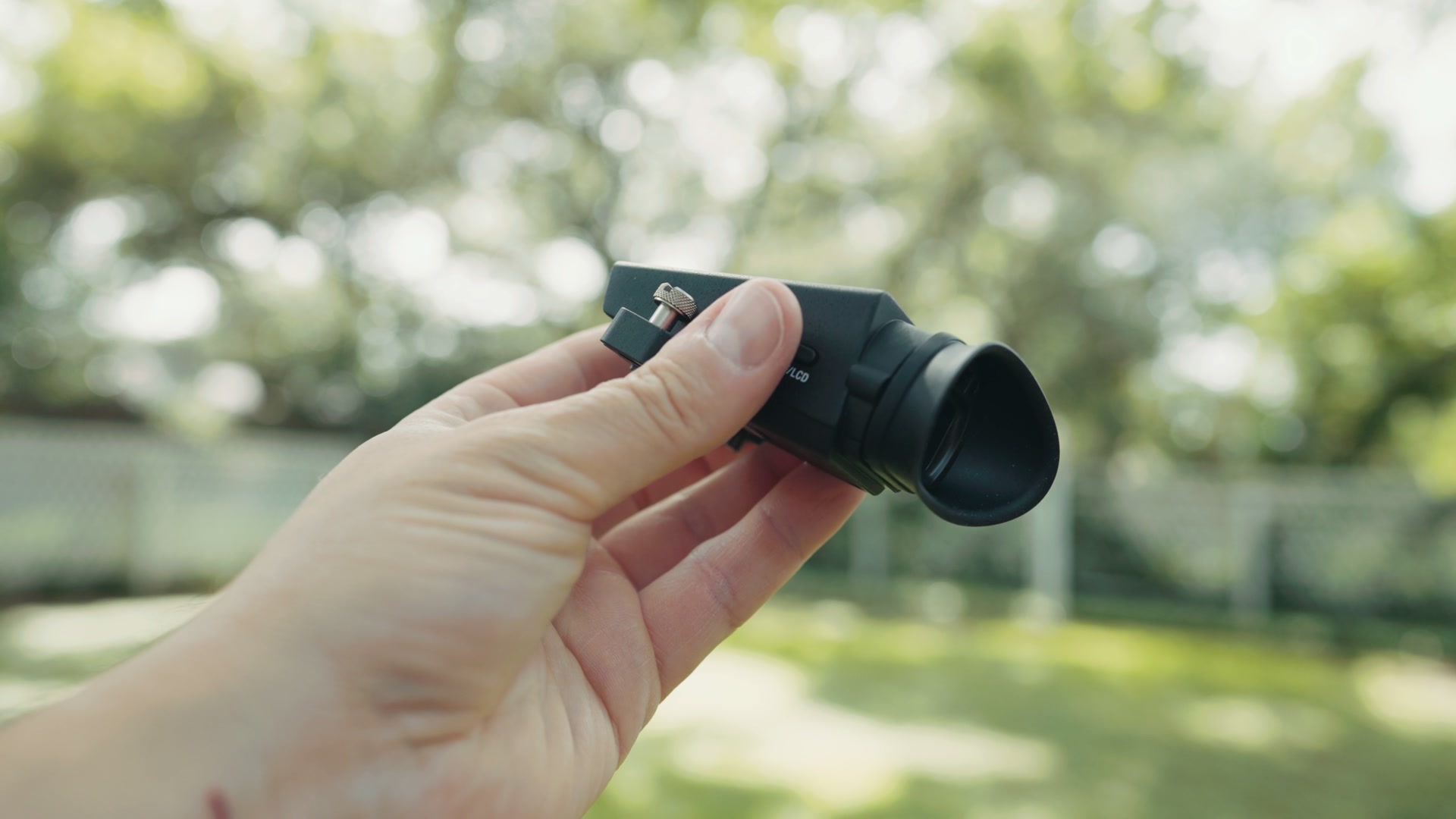 The Sony FX5's detachable electronic viewfinder held in one hand outdoors