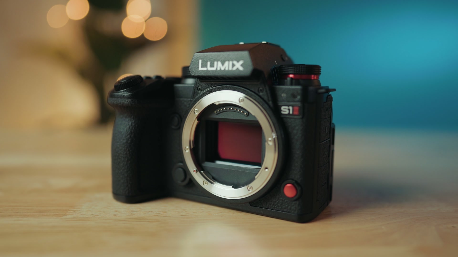 The Panasonic Lumix S1 II camera body on a desk with no lens attached, showing the lens mount and sensor