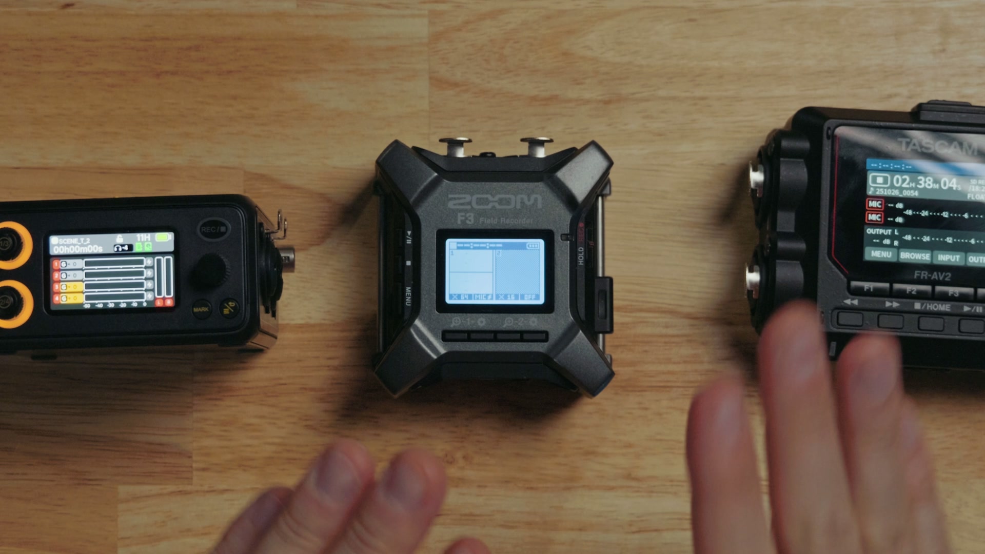 Close up comparison of the black and white Zoom F3 screen next to the color screens on the Tascam FR-AV2 and Deity PR-4