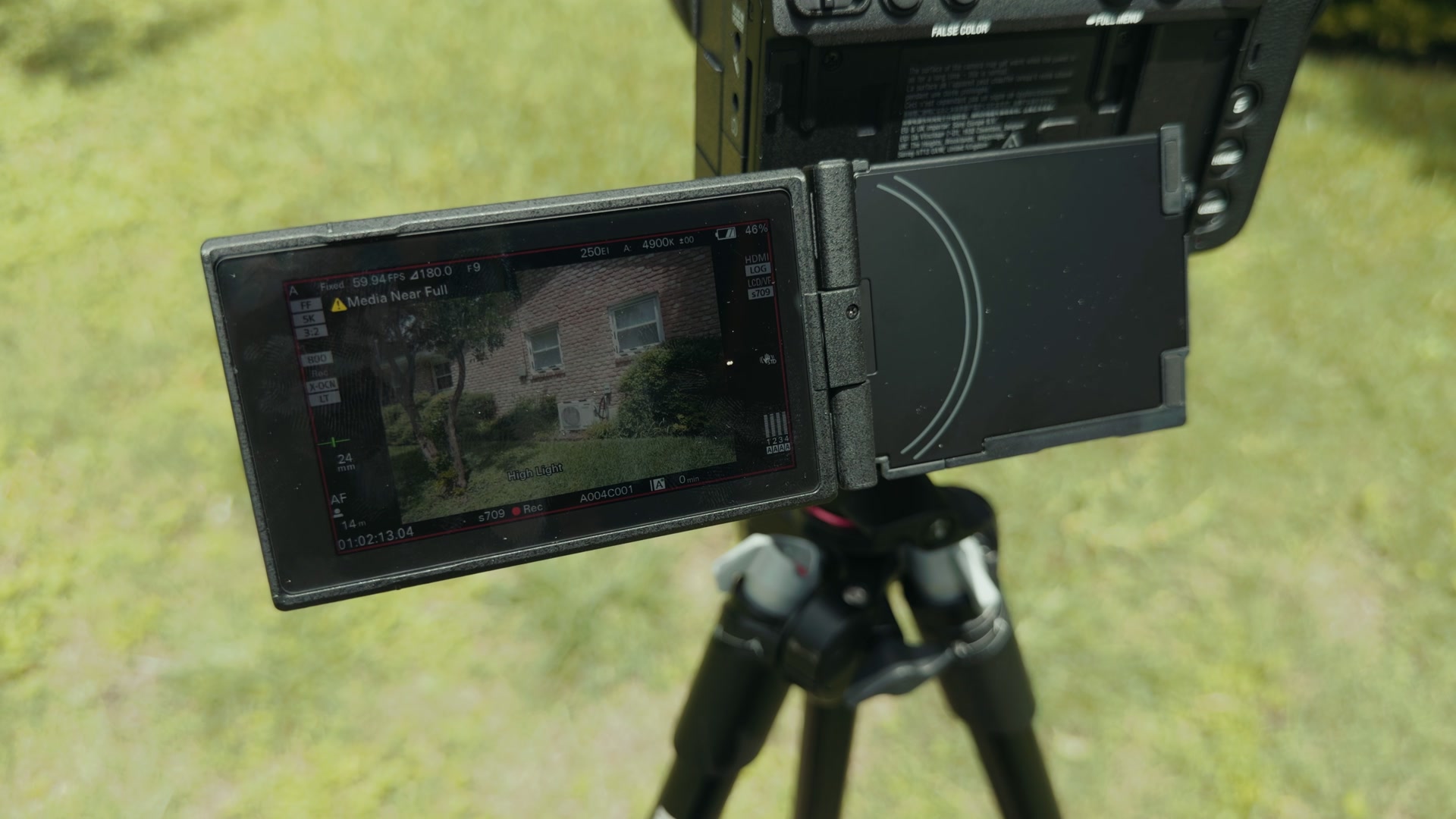 A yellow triangle warning icon on the Sony FX5 screen indicating the memory card is nearly full