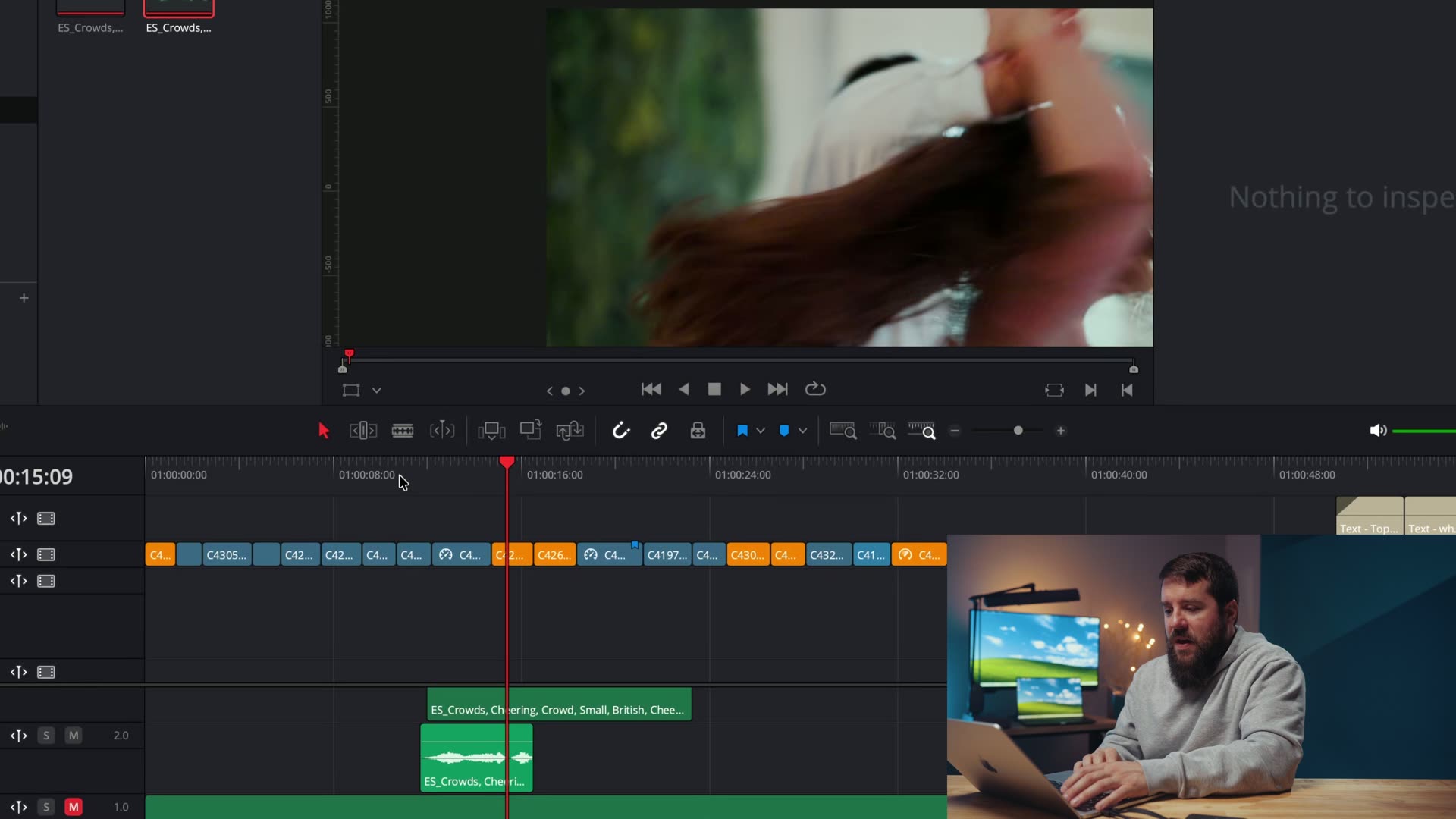 An editing timeline with two crowd cheering sound effect tracks layered beneath the original camera audio
