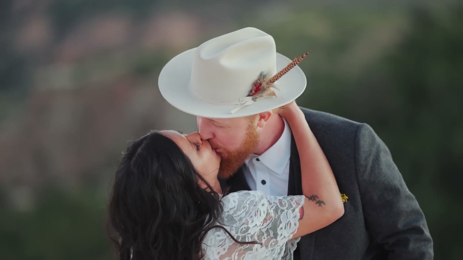 A wedding couple kissing, filmed on the 135mm with a very shallow depth of field