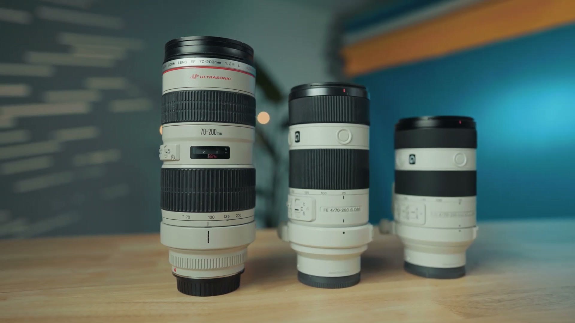 Three 70-200mm lenses side by side, a Canon EF, the original Sony F4 and the new mark two