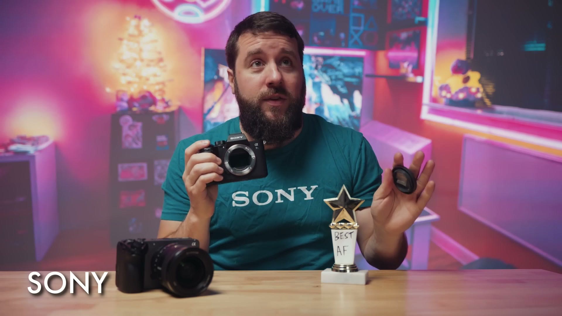 Matt dressed as Sony holding up the a7R VI body with the lens removed