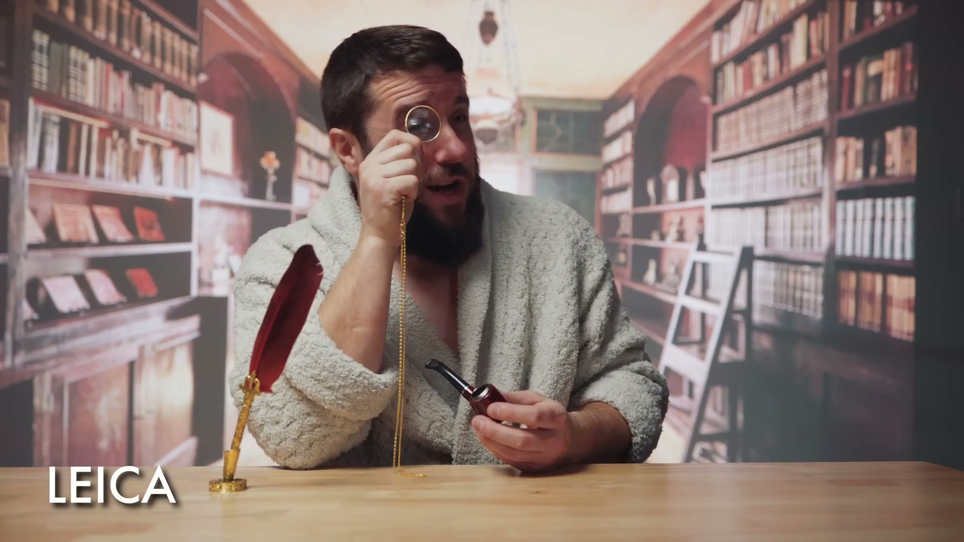 Matt dressed as Leica holding a monocle up to his eye in the library