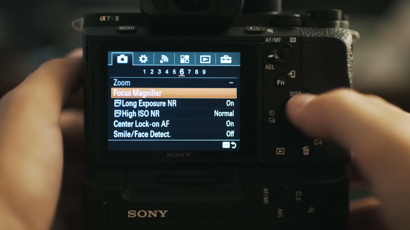 Camera menu page showing Focus Magnifier, noise reduction and face detection settings