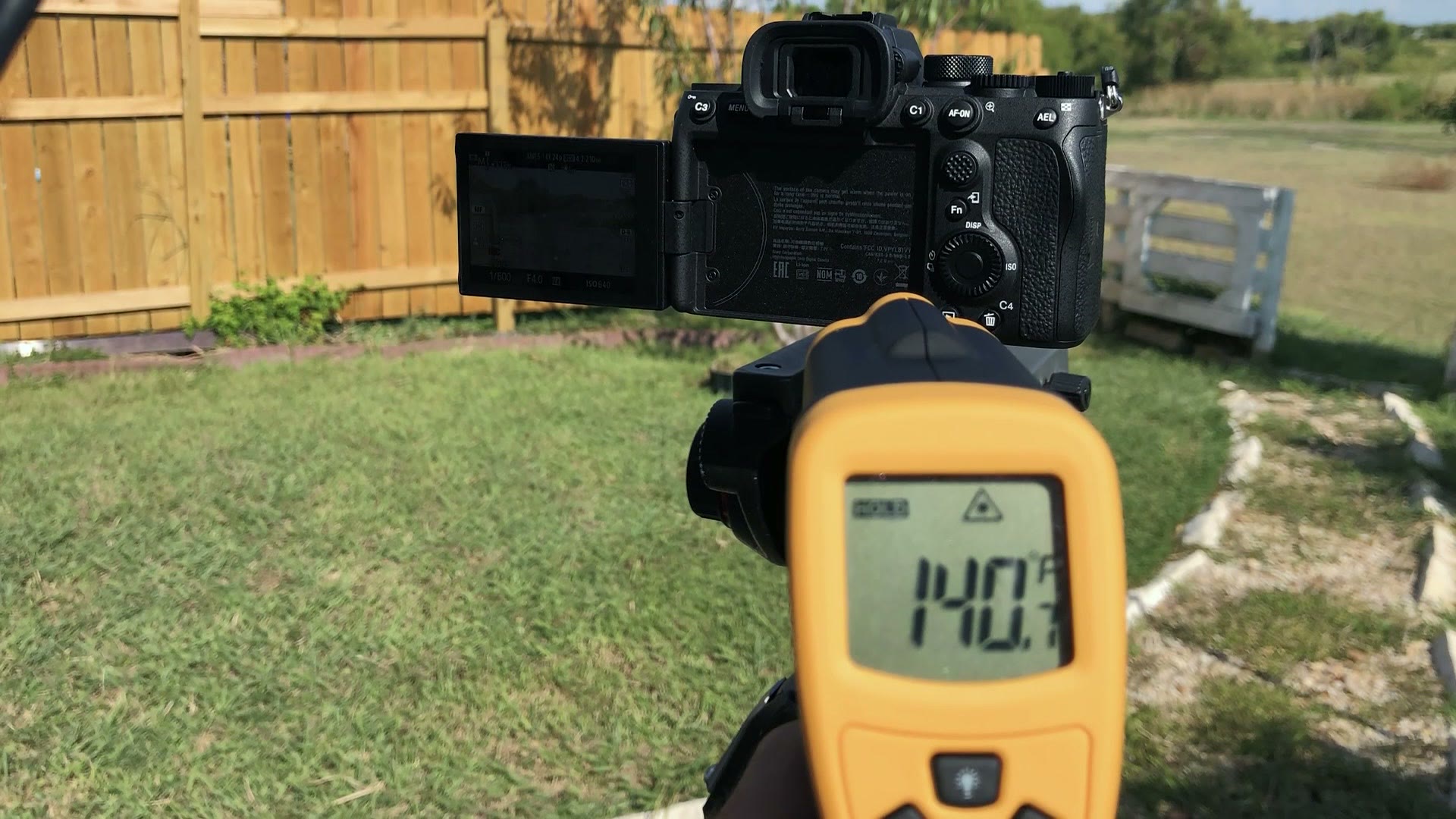 An infrared thermometer pointed at the back of the Sony a7S III outdoors, reading 140 degrees Fahrenheit