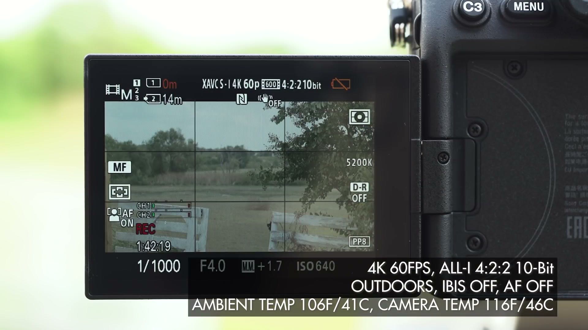 The a7S III rear screen recording XAVC S-I 4K 60p with the timer at 1 hour 42 minutes and the battery indicator empty, overlay reading ambient temp 106F