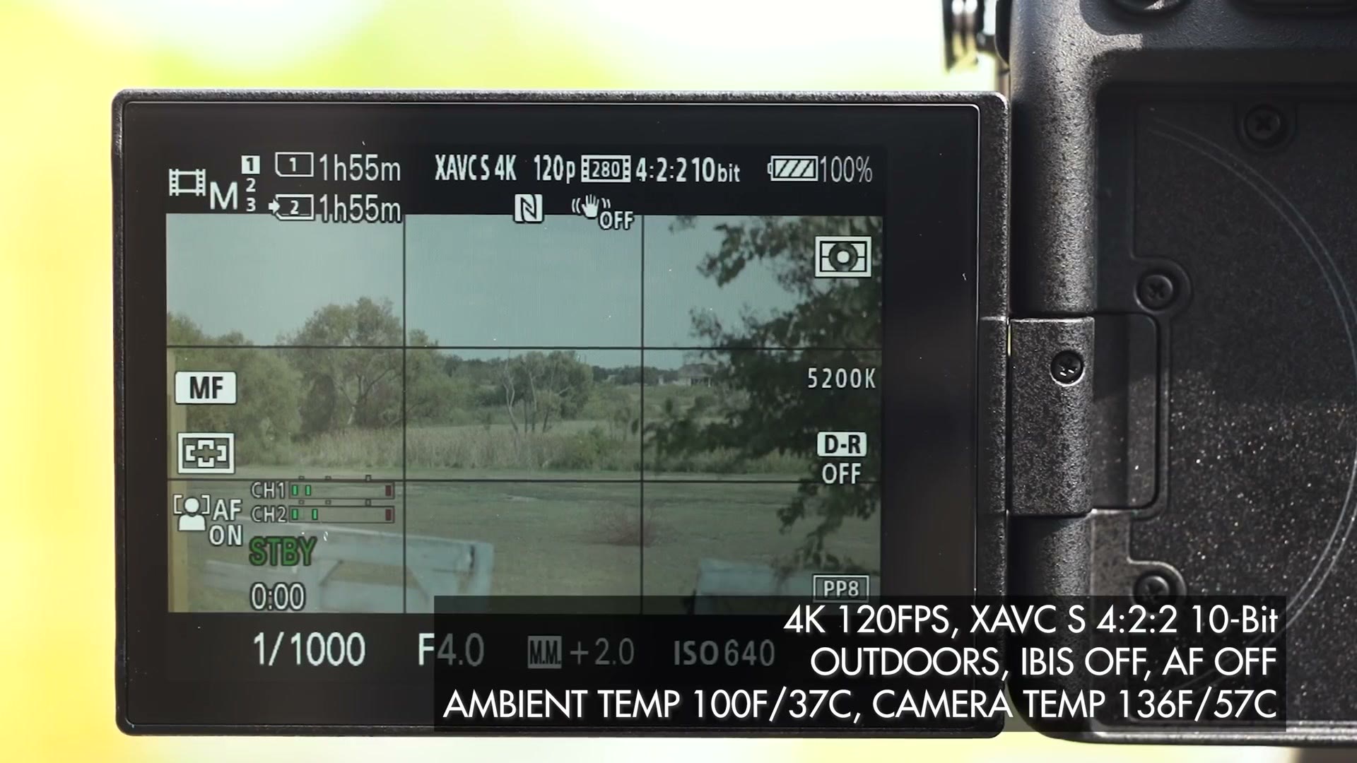 The a7S III rear screen in standby at XAVC S 4K 120p, with an overlay reading 4K 120FPS XAVC S 4:2:2 10-bit, outdoors, IBIS off, AF off, ambient temp 100F, camera temp 136F