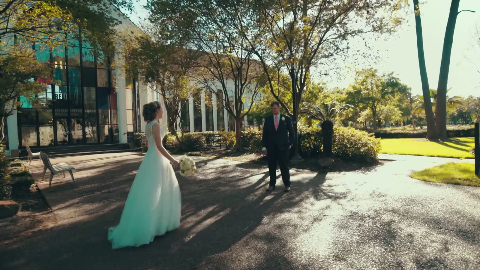 Bride and groom facing each other outside the chapel entrance during a first-look moment in daylight