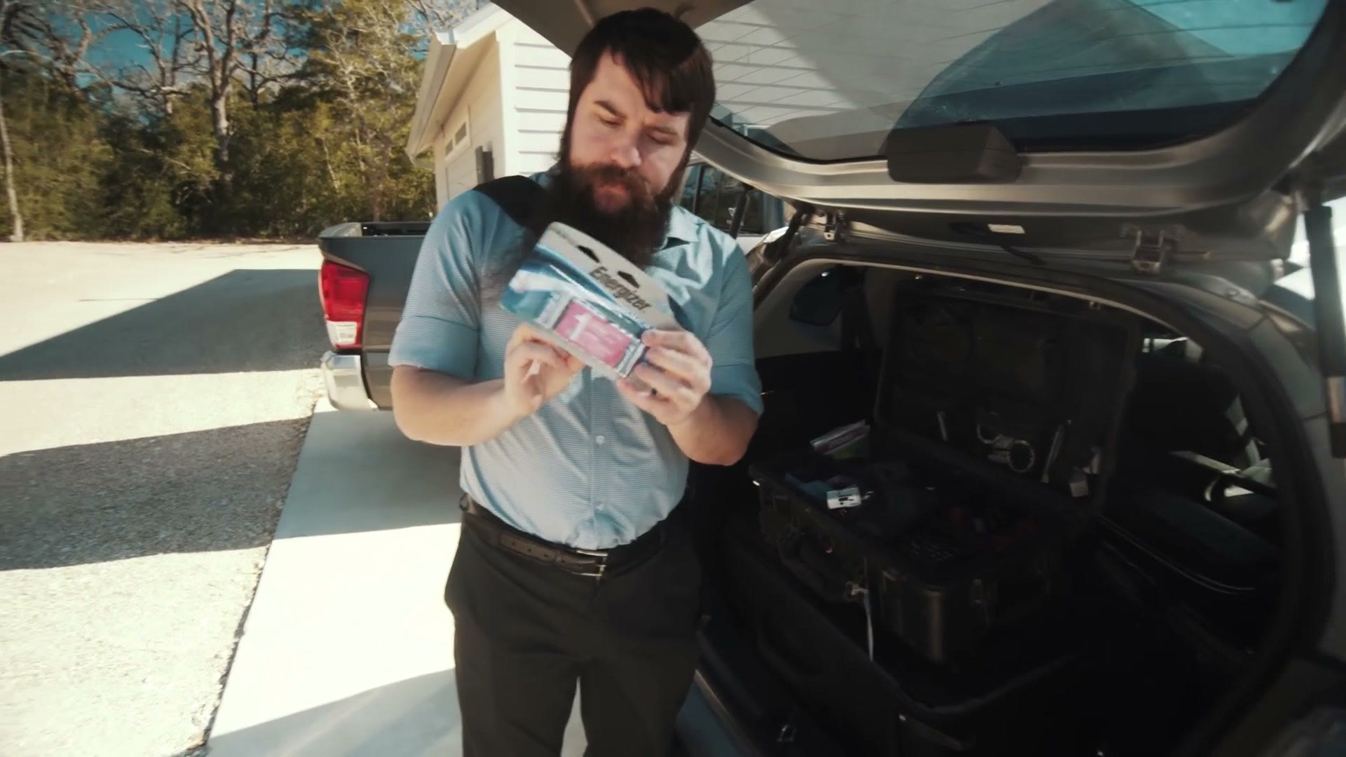 Matt holding a pack of Energizer Ultimate Lithium AAA batteries.
