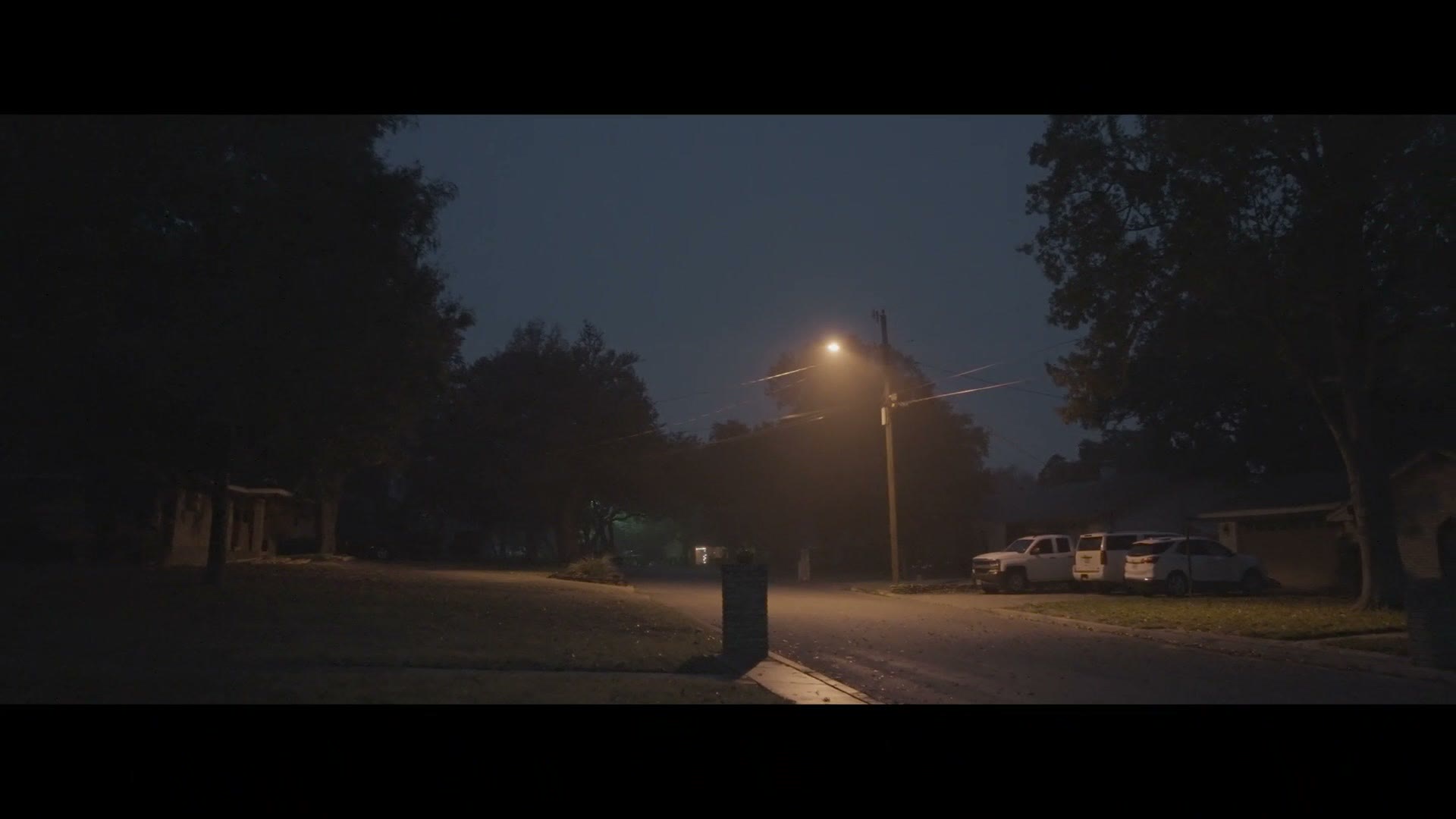 De-squeezed anamorphic footage of a street at night with a streetlight