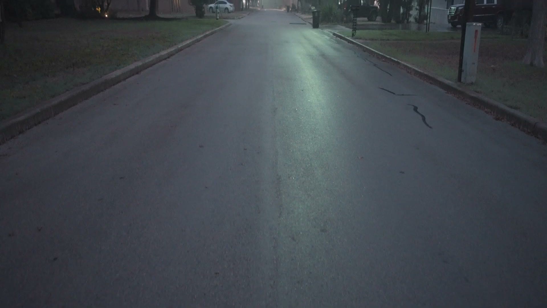 Squeezed anamorphic footage of a residential street filling the whole 16:9 frame
