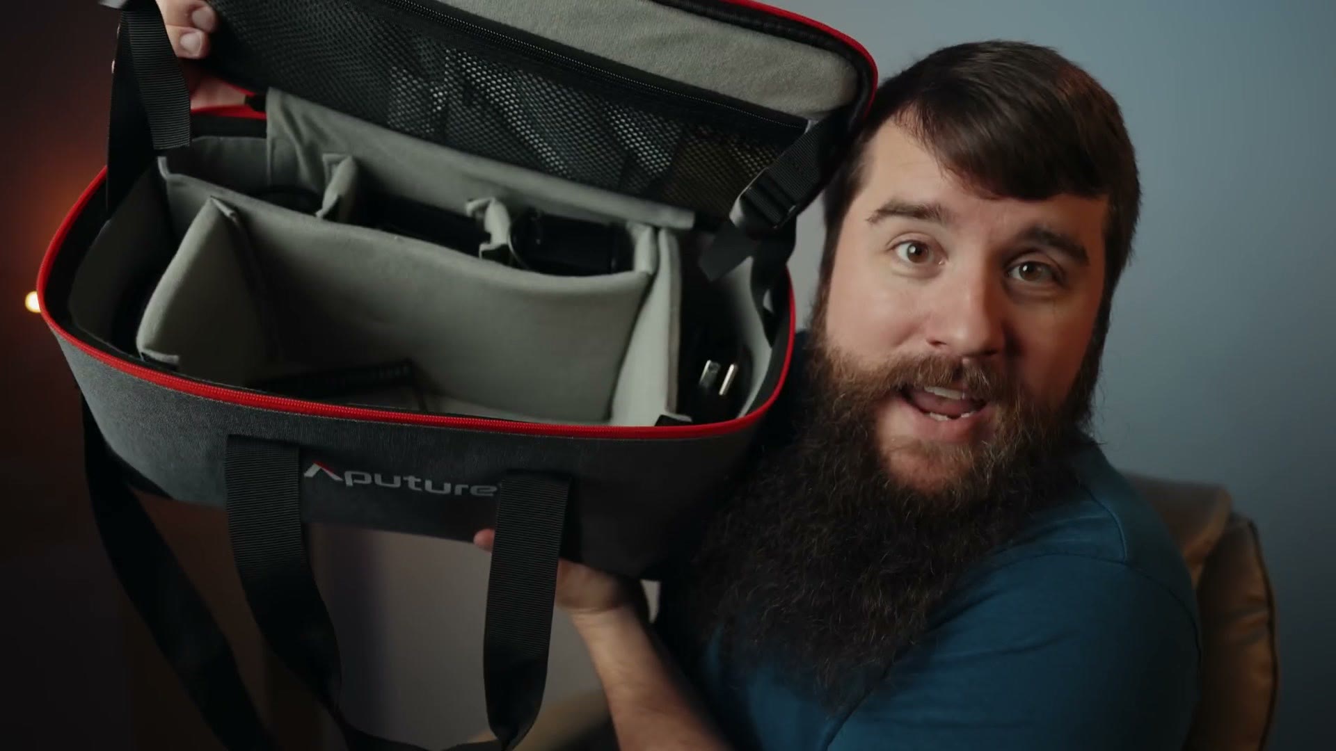Matt holding open the padded Aputure carry case, showing dividers and storage compartments inside.