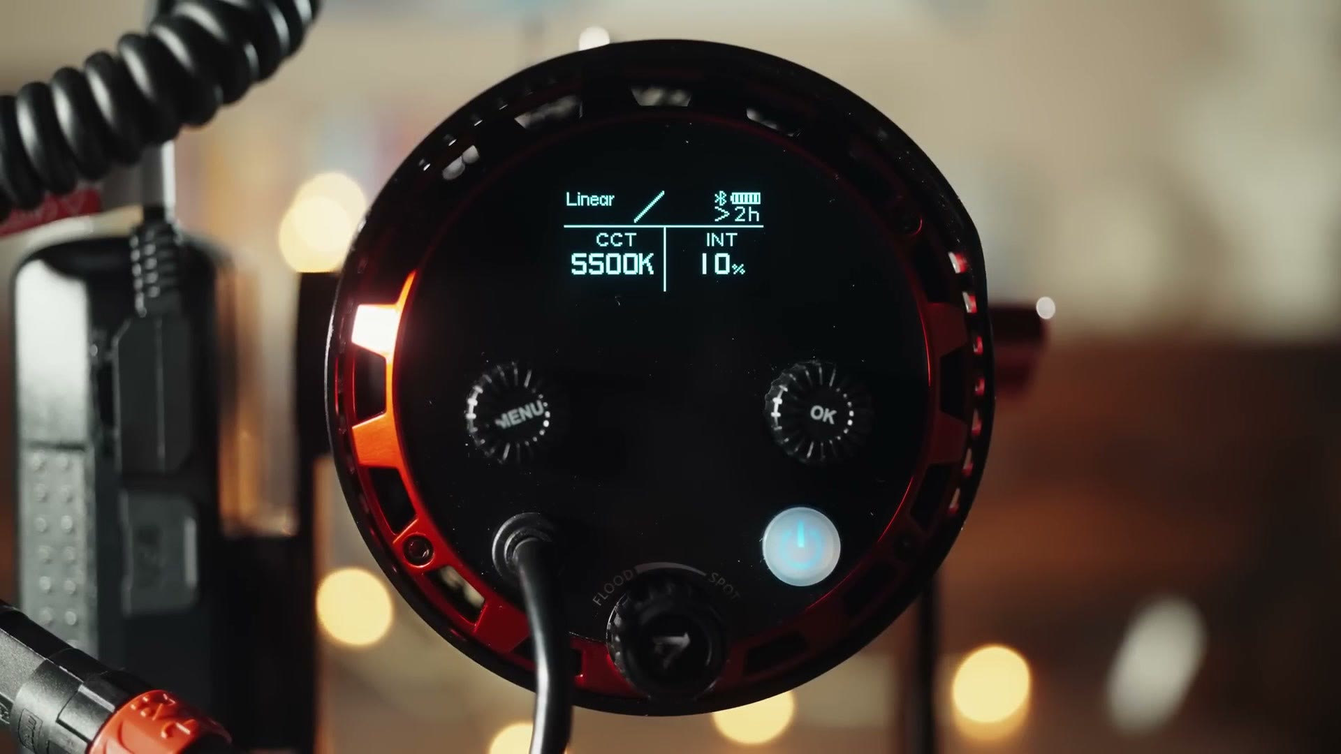 The rear control panel of the Aputure 60x showing a display reading Linear, CCT 5500K, INT 10 percent, a Bluetooth icon and more than two hours of battery remaining.
