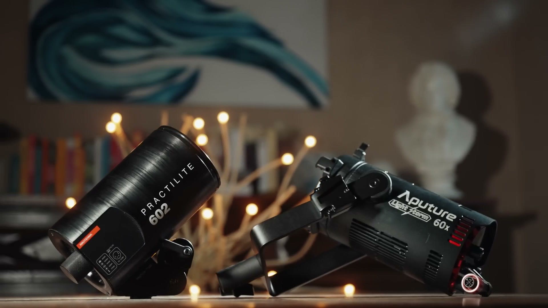 A Kinotehnik Practilite 602 and an Aputure Light Storm 60x side by side on a table, almost identical in length and diameter.