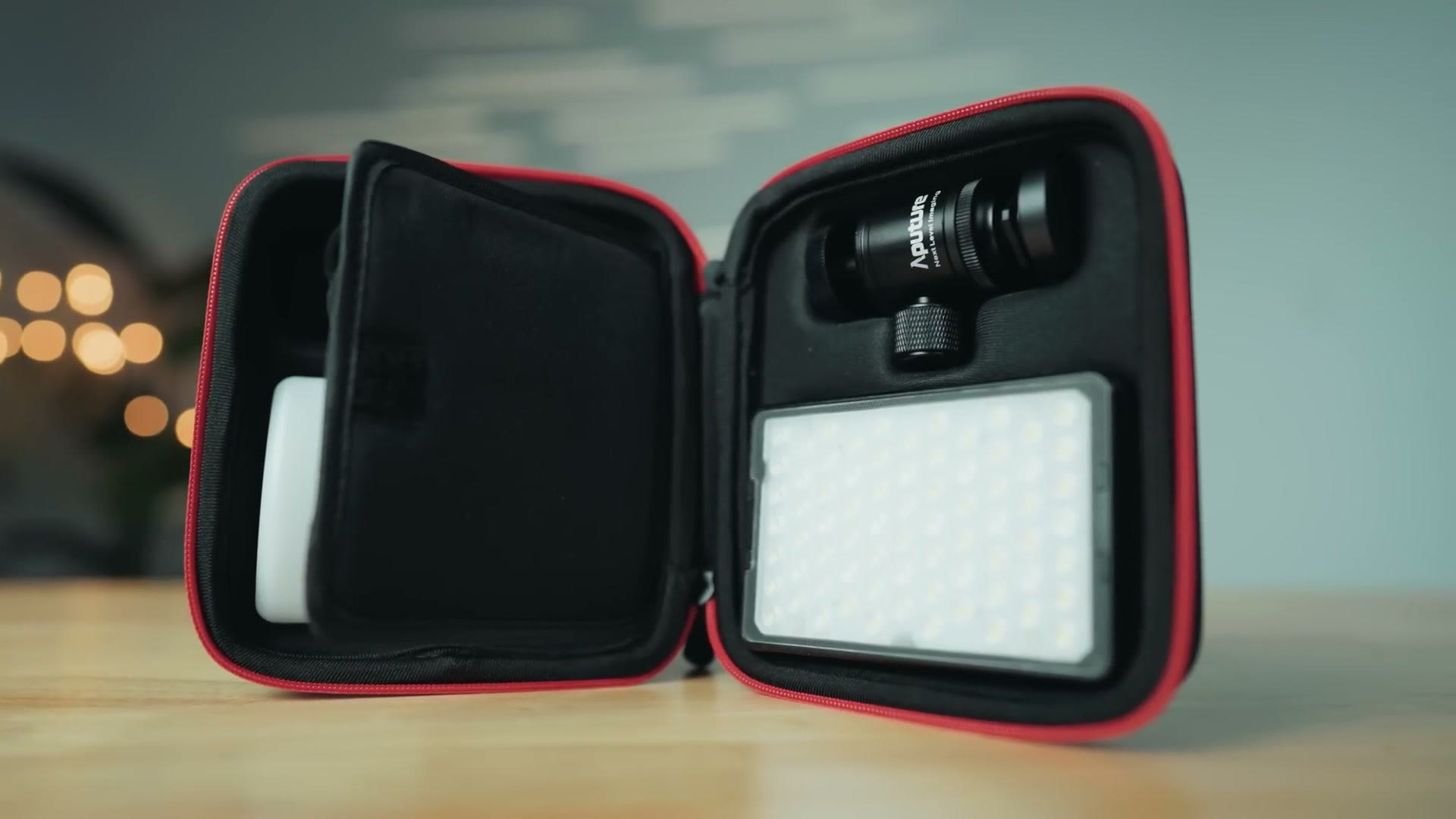 The Aputure MC Pro protective case open, holding the light and the ball head mount