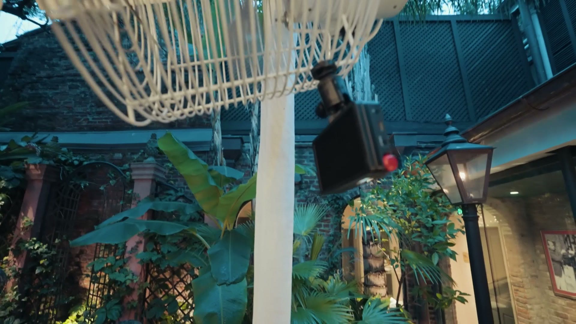 Aputure MC Pro clamped high on an outdoor structure at a wedding venue