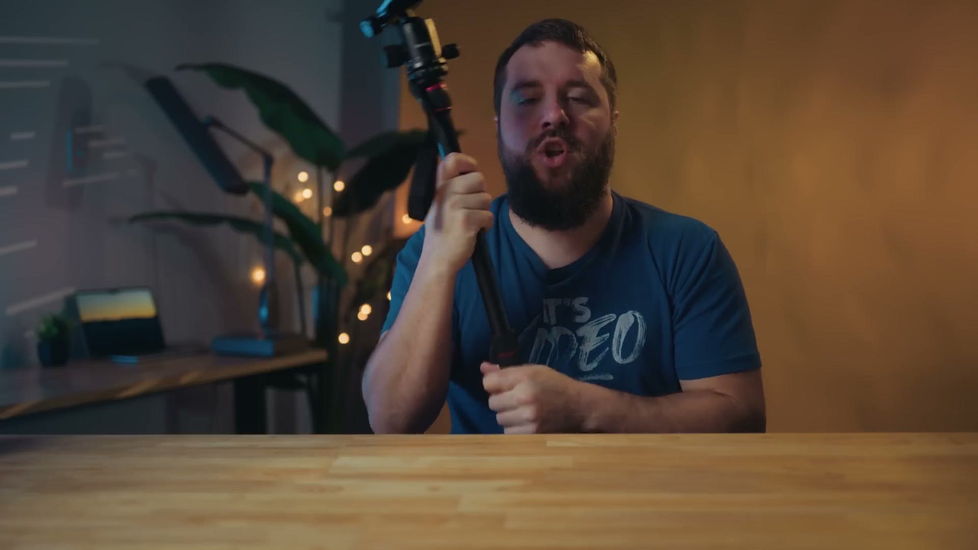 Matt holding up a monopod assembled from one tripod leg and the tripod centre column