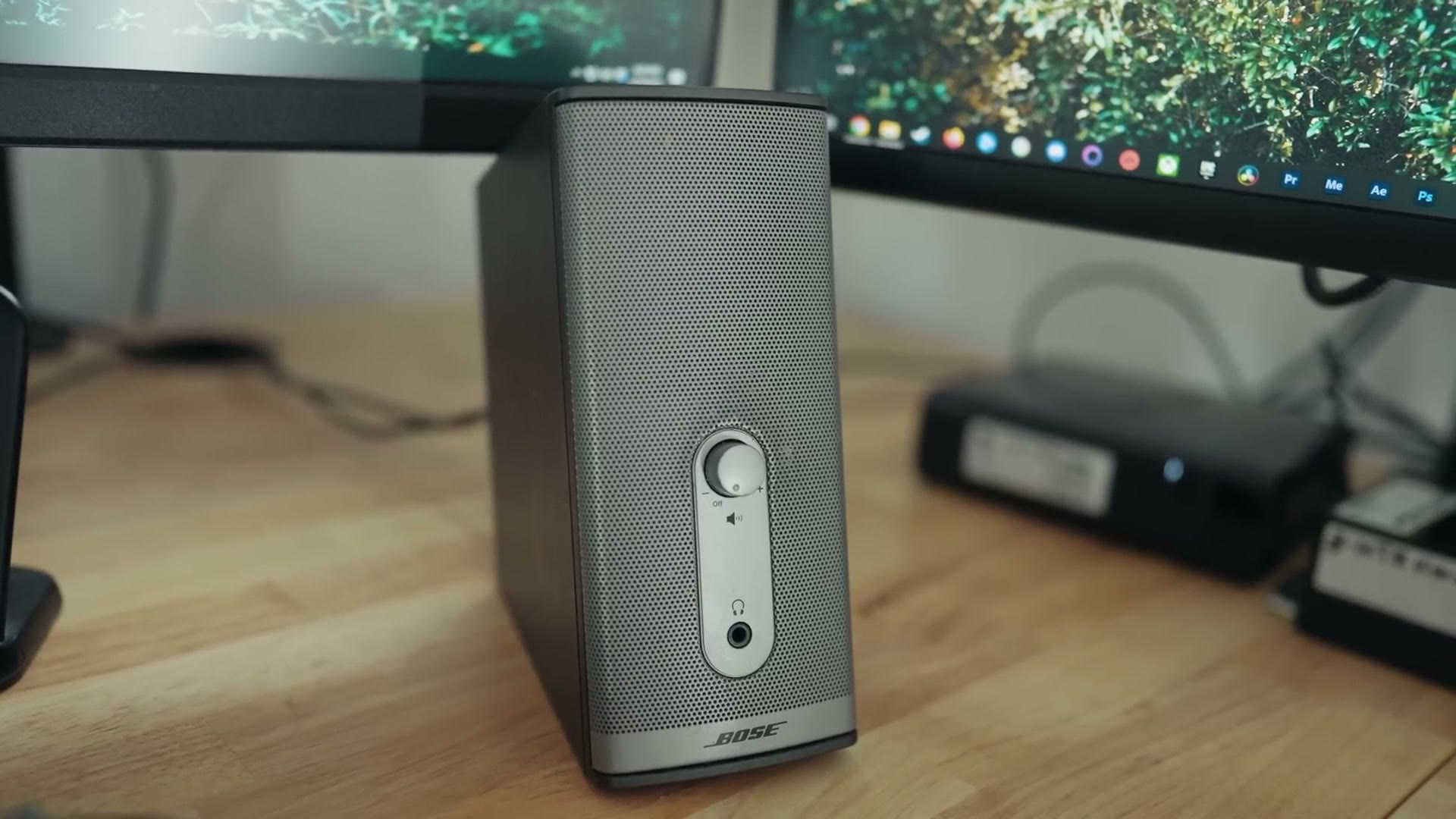 Bose desktop speakers beside the monitors