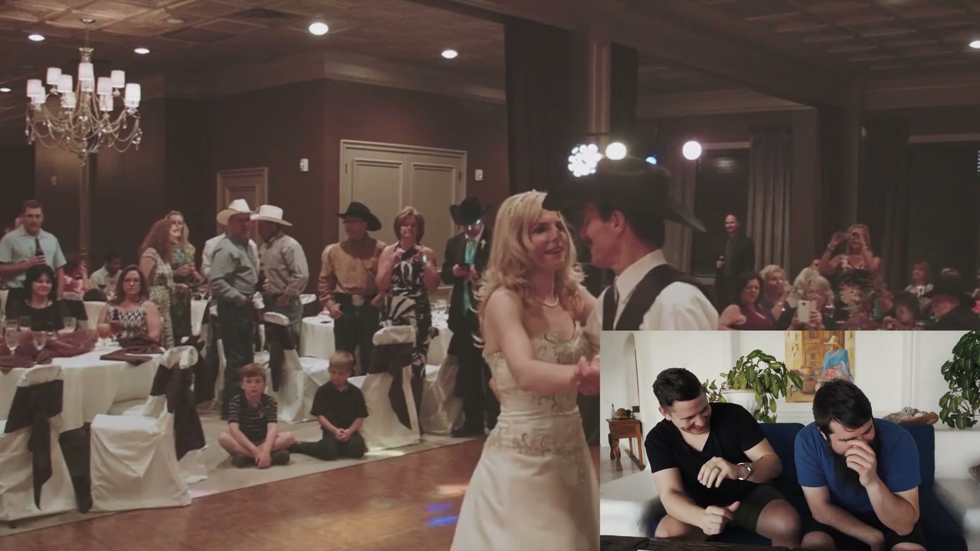 A high wide shot across a wedding reception dance floor with guests in cowboy hats, filmed from a jib.