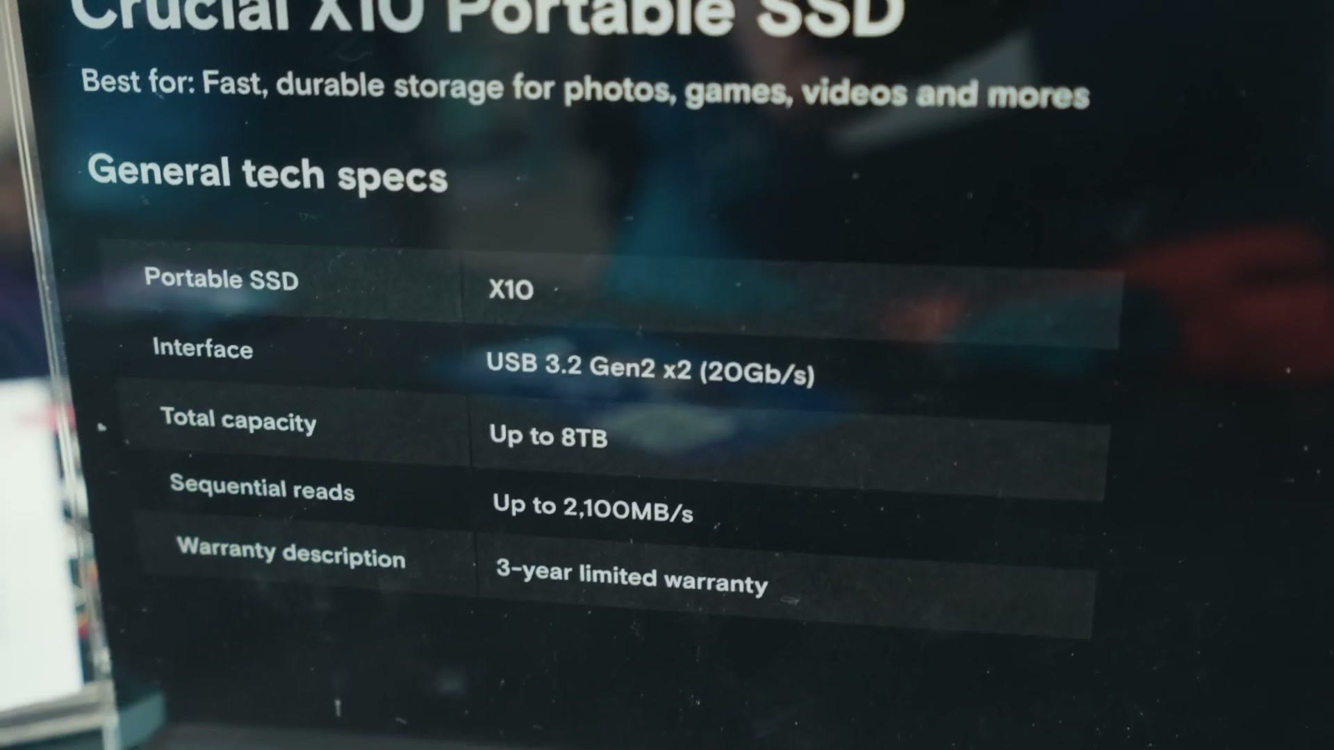 Spec board at the Crucial booth listing the X10 portable SSD at USB 3.2 Gen 2x2, up to 8TB, and reads up to 2,100MB per second