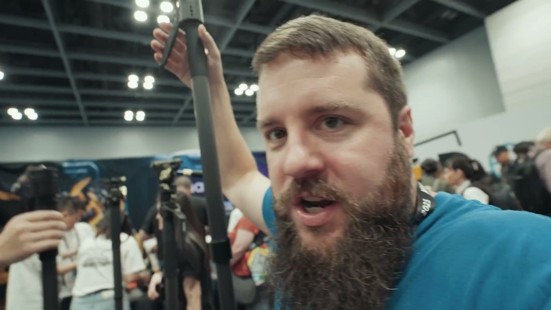 Matt holding a Tribex monopod fully extended above his head on the show floor