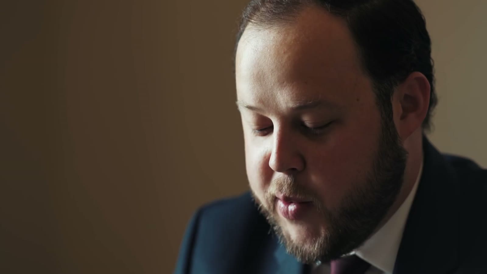 The groom reading a letter, visibly emotional