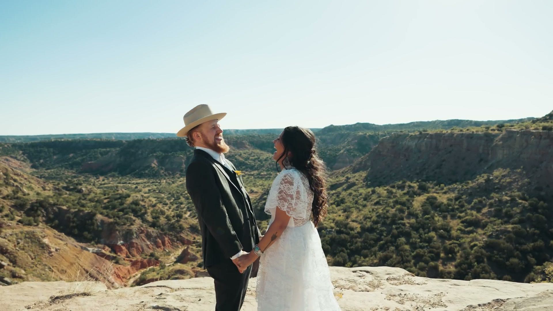 The couple standing together on the canyon rim