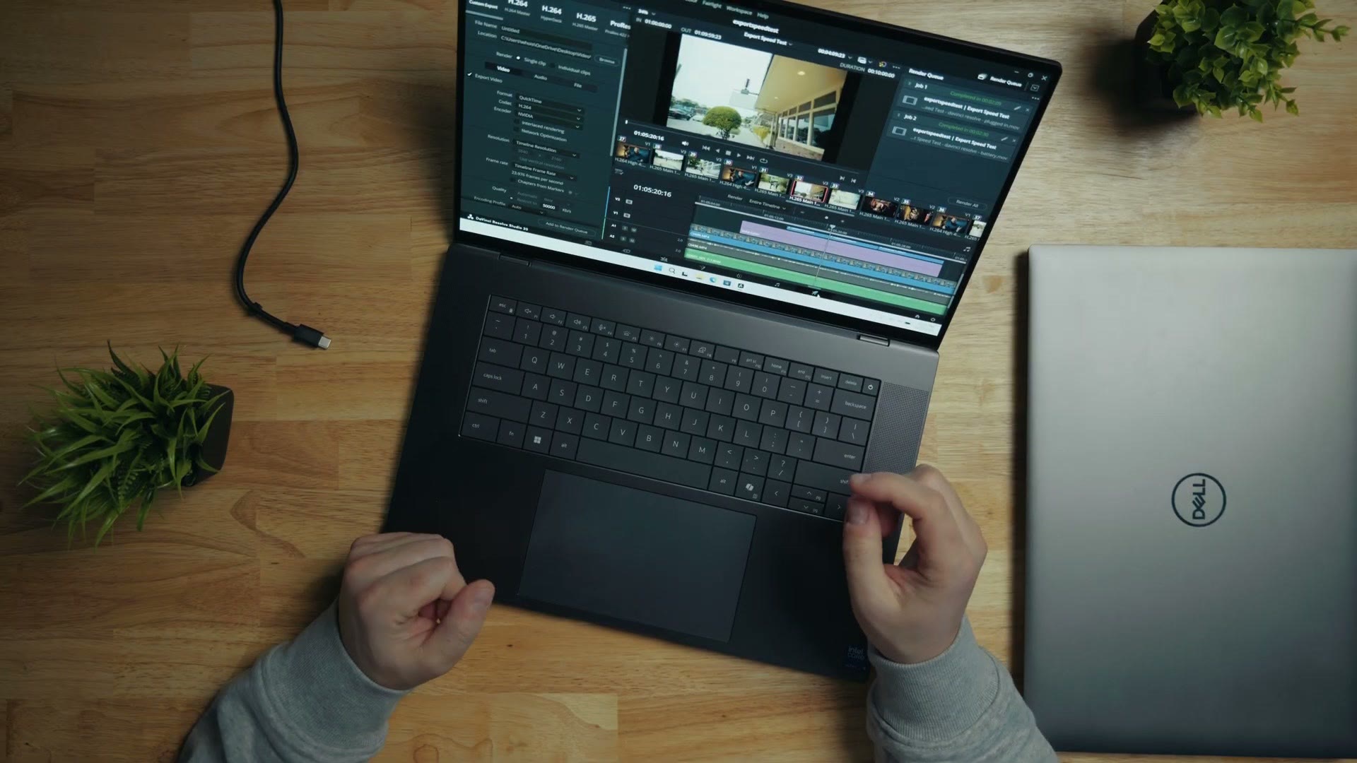 Dell Pro Max 16 Premium open on a desk with a Premiere Pro timeline on screen, a closed second Dell beside it