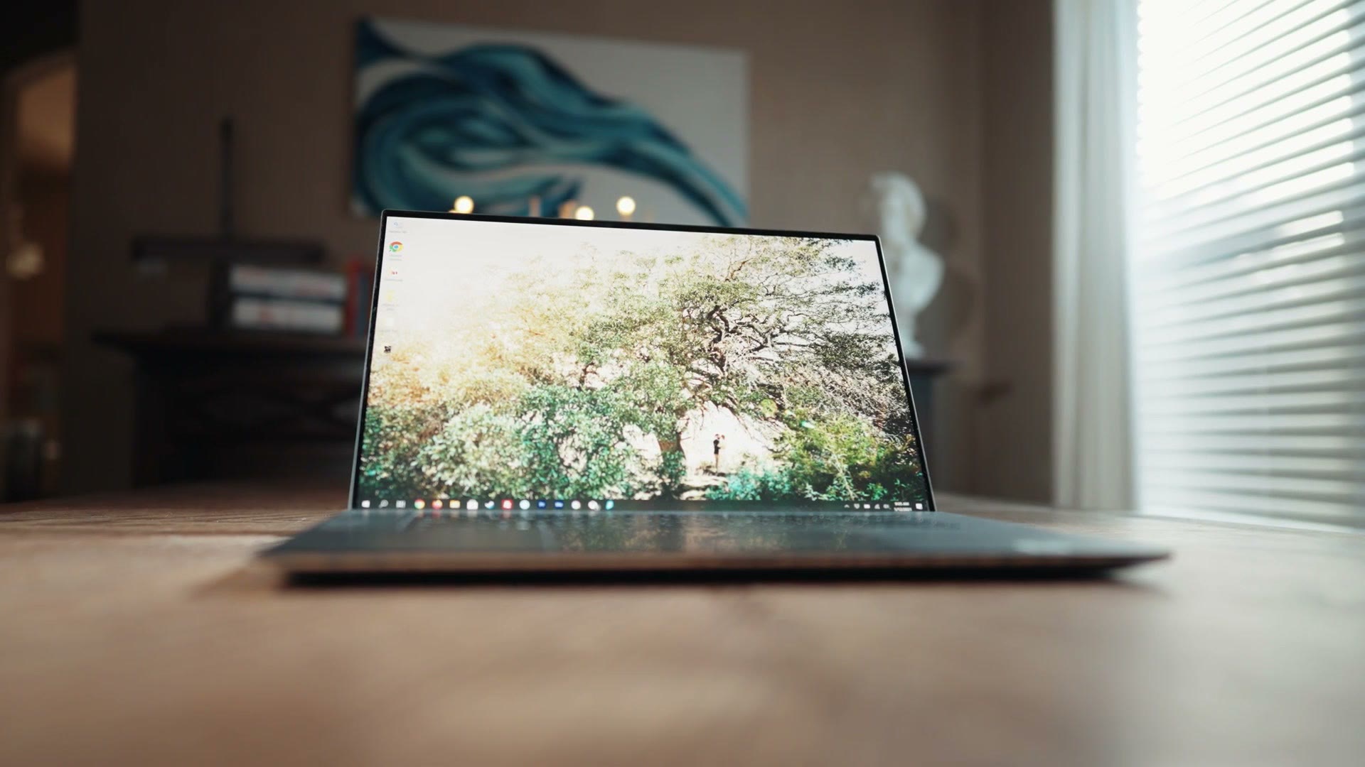 Dell Precision 5680 open on a table showing a bright image on the OLED screen