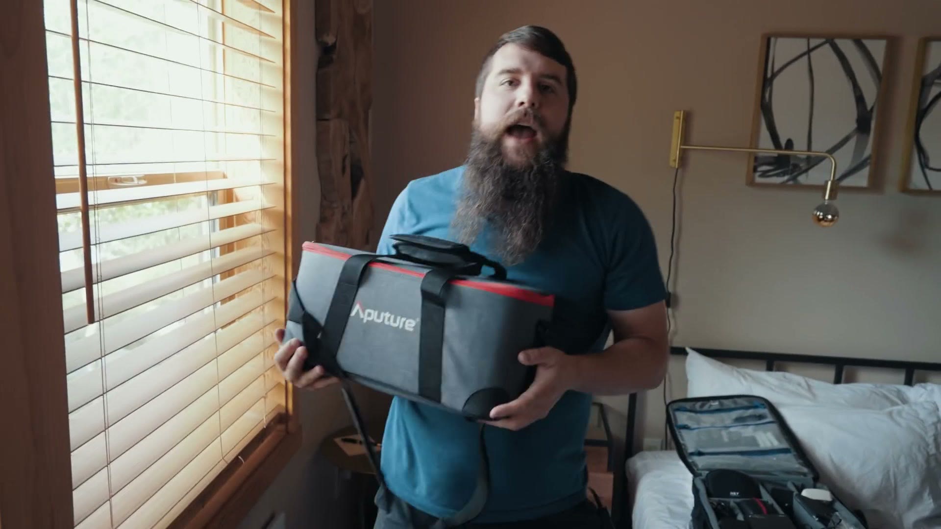 Matt holding the padded grey Aputure carry case for a 60x LED light.