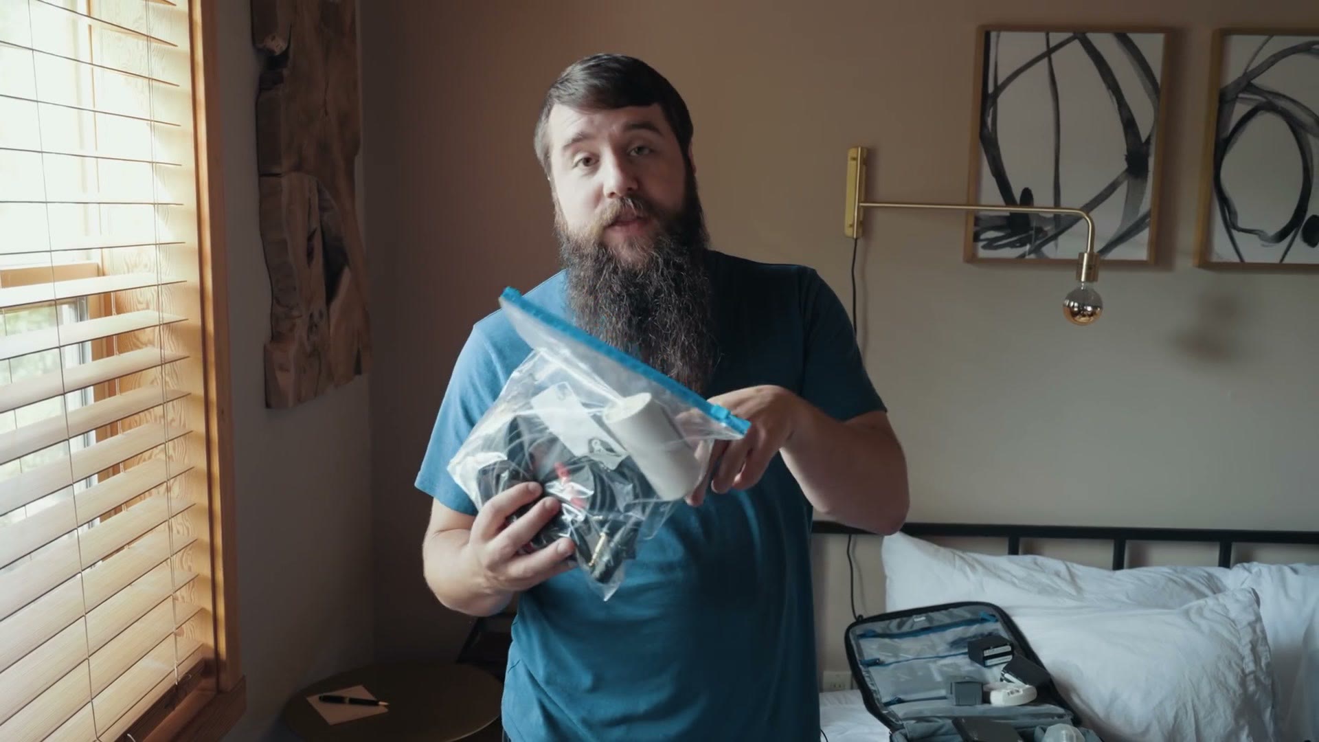 Matt holding a clear ziplock bag full of audio cables and adapters.