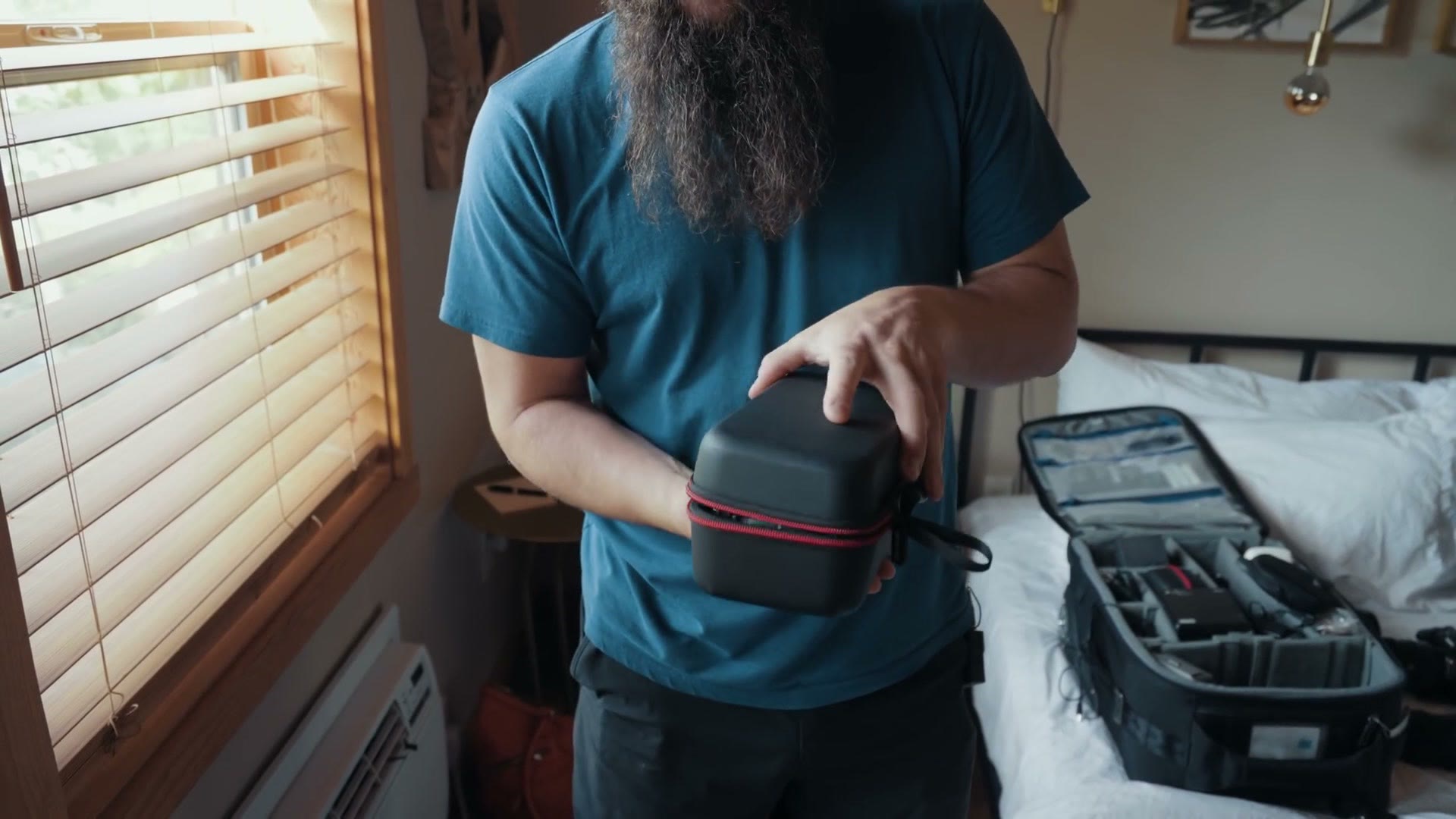 Matt holding a small black hard case for a DJI Mavic 2 Pro drone.