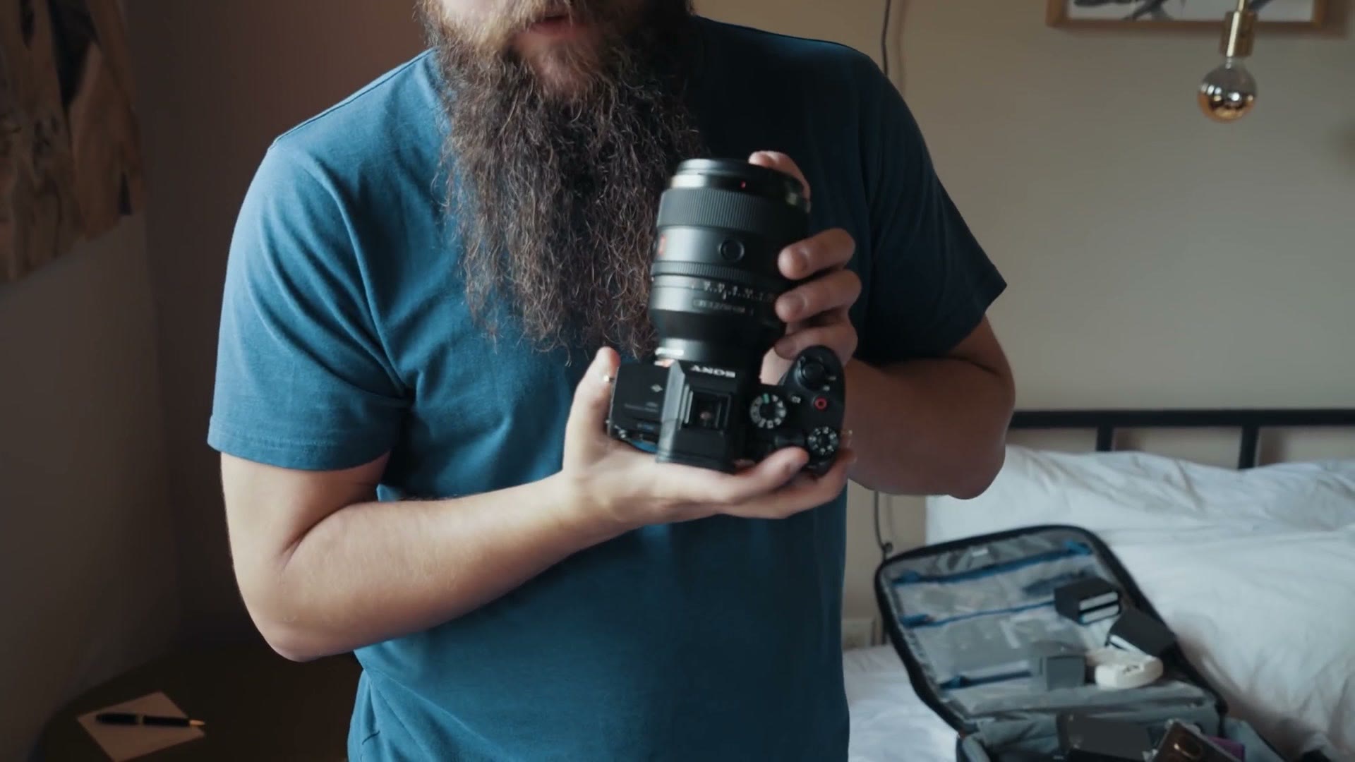 Matt holding a Sony a7S III with the Sony 50mm f/1.2 GM lens mounted on it.