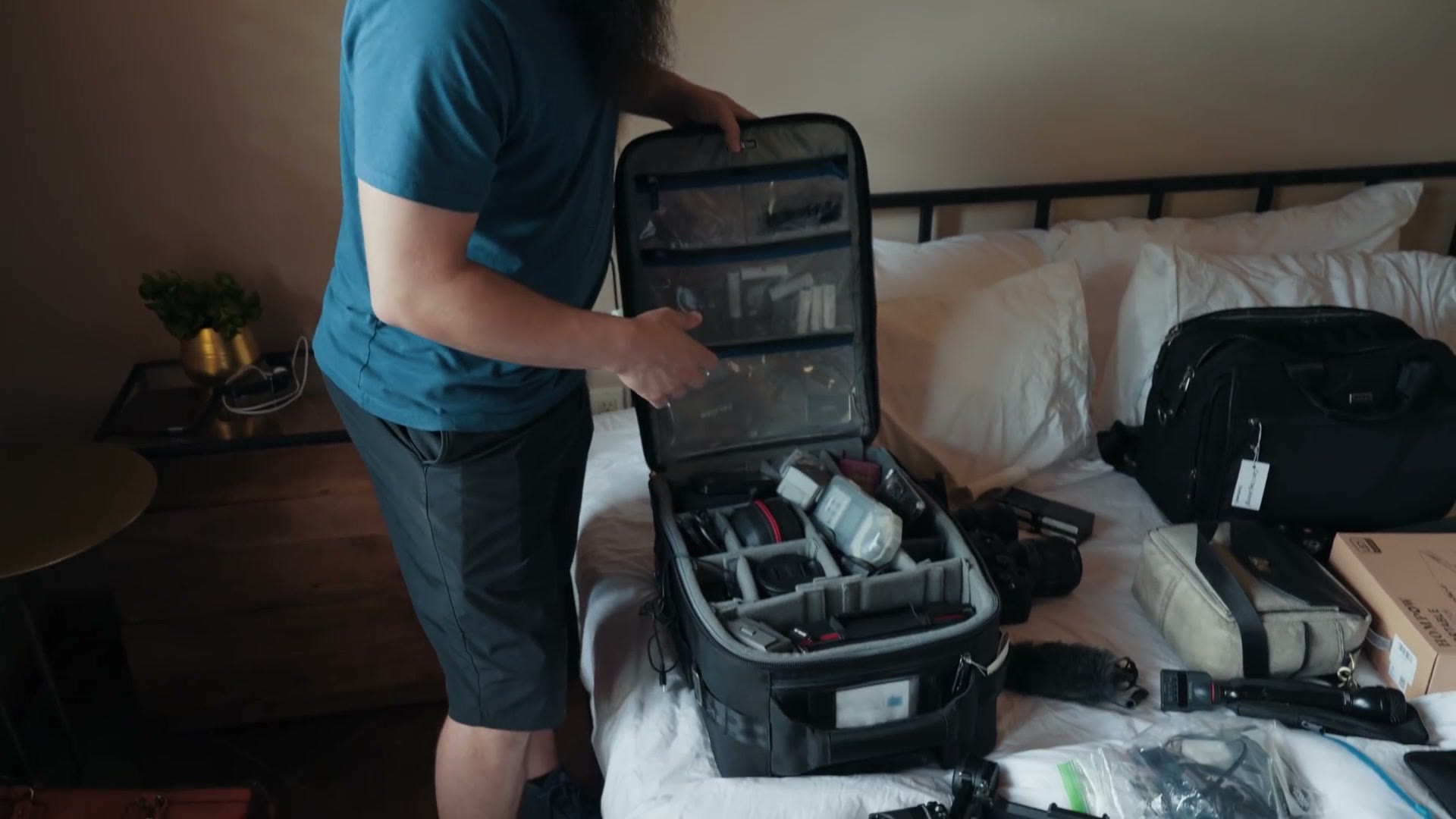 An open Think Tank Airport International rolling case packed with lenses, camera bodies and dividers.