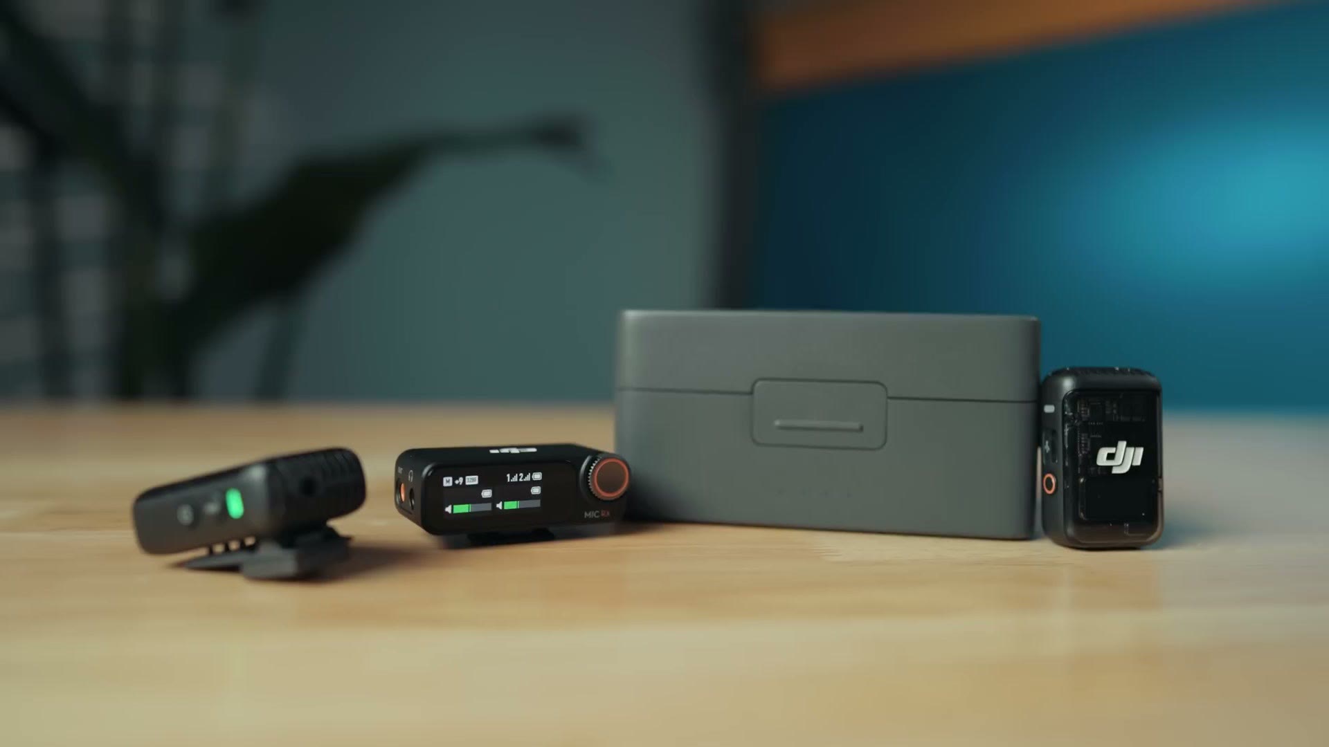 DJI Mic 2 transmitters, receiver and charging case laid out on a table