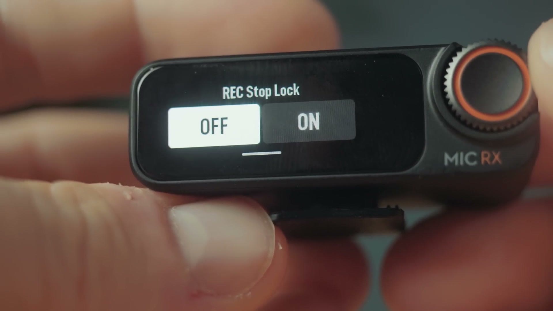 DJI Mic 2 receiver showing the REC Stop Lock setting with OFF and ON options