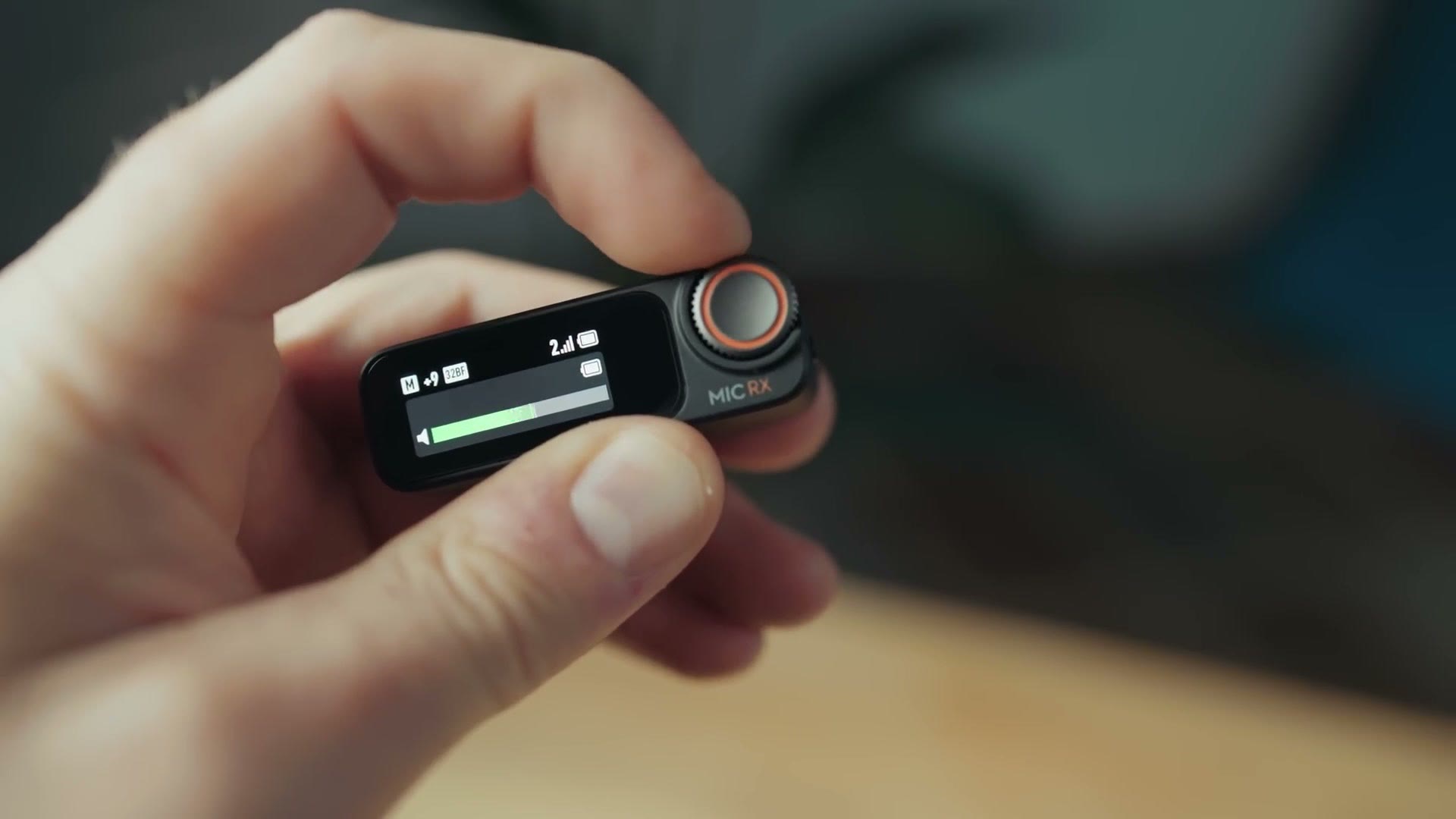 DJI Mic 2 receiver showing its touchscreen and control dial
