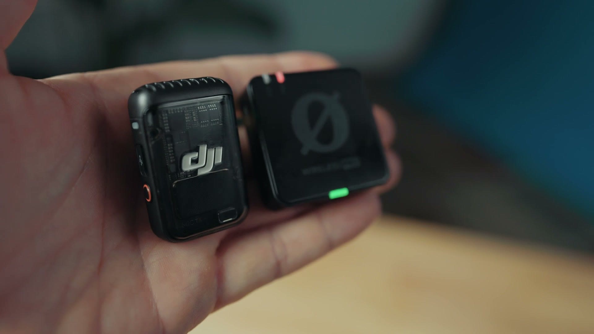 DJI Mic 2 and Rode Wireless PRO transmitters side by side in hand