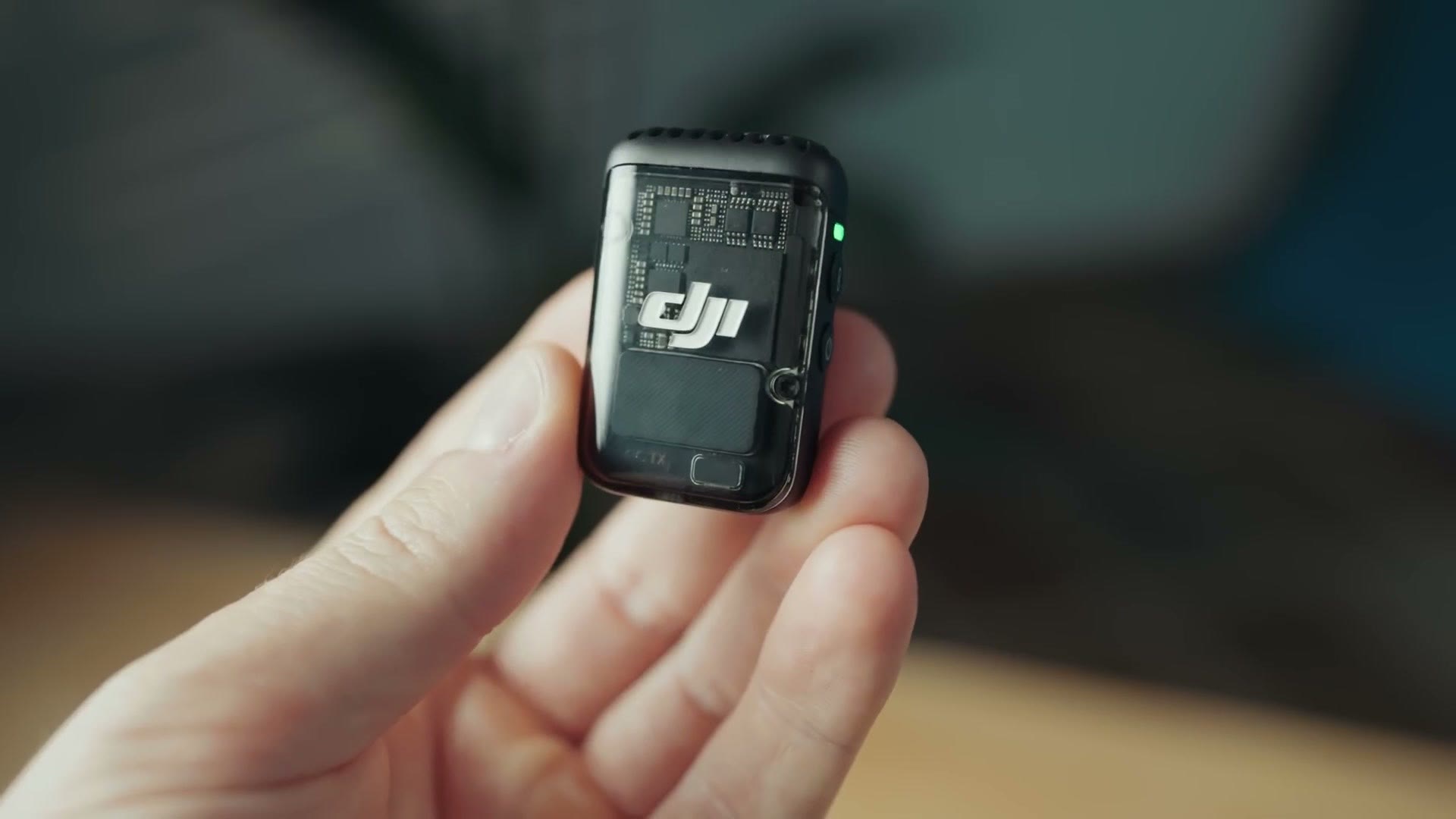 DJI Mic 2 transmitter showing the circuit board through its transparent front