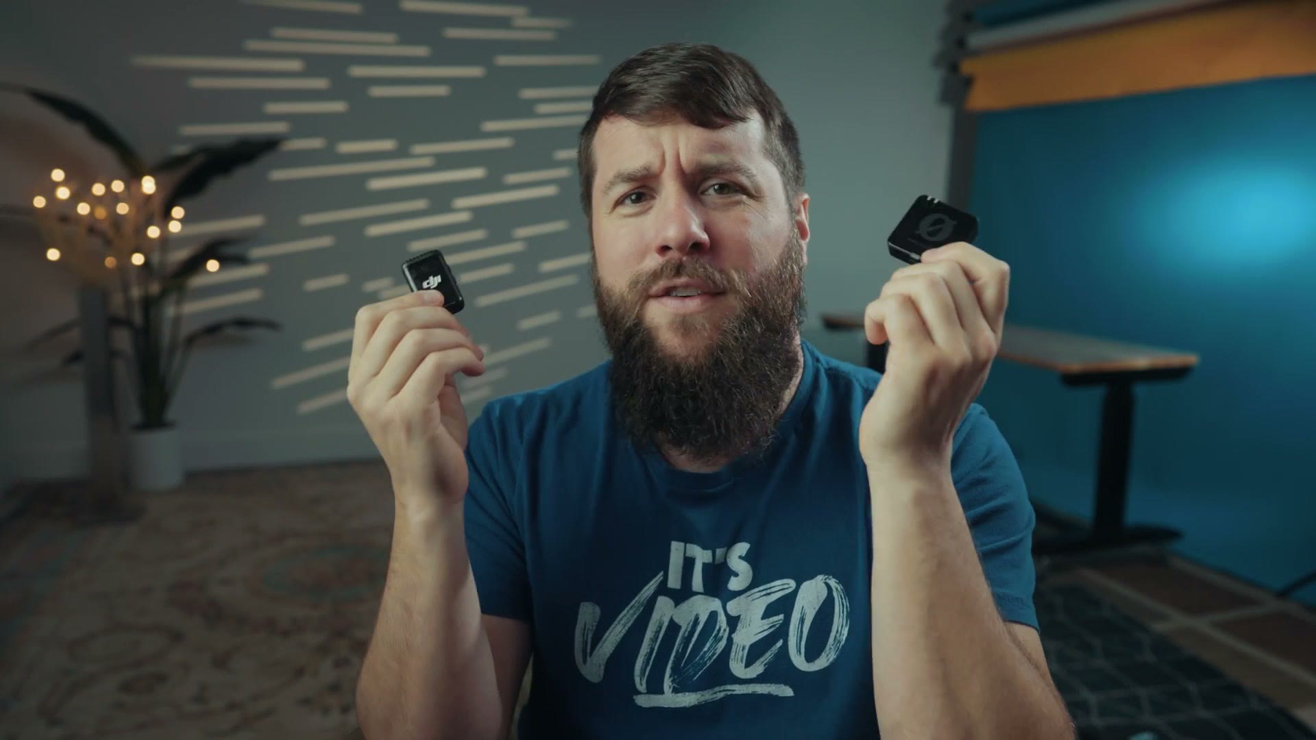 Matt Johnson holding the DJI Mic 2 and Rode Wireless PRO transmitters