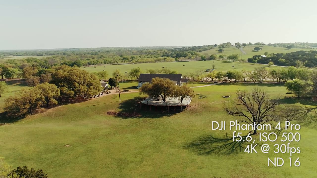 Aerial drone view of the reception deck under an oak tree, overlay reading DJI Phantom 4 Pro, f5.6, ISO 500, ND16