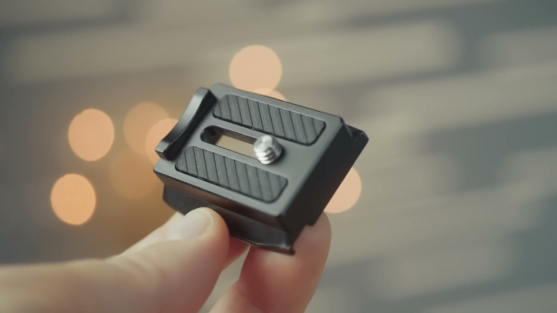 DJI quick release plate held between two fingers