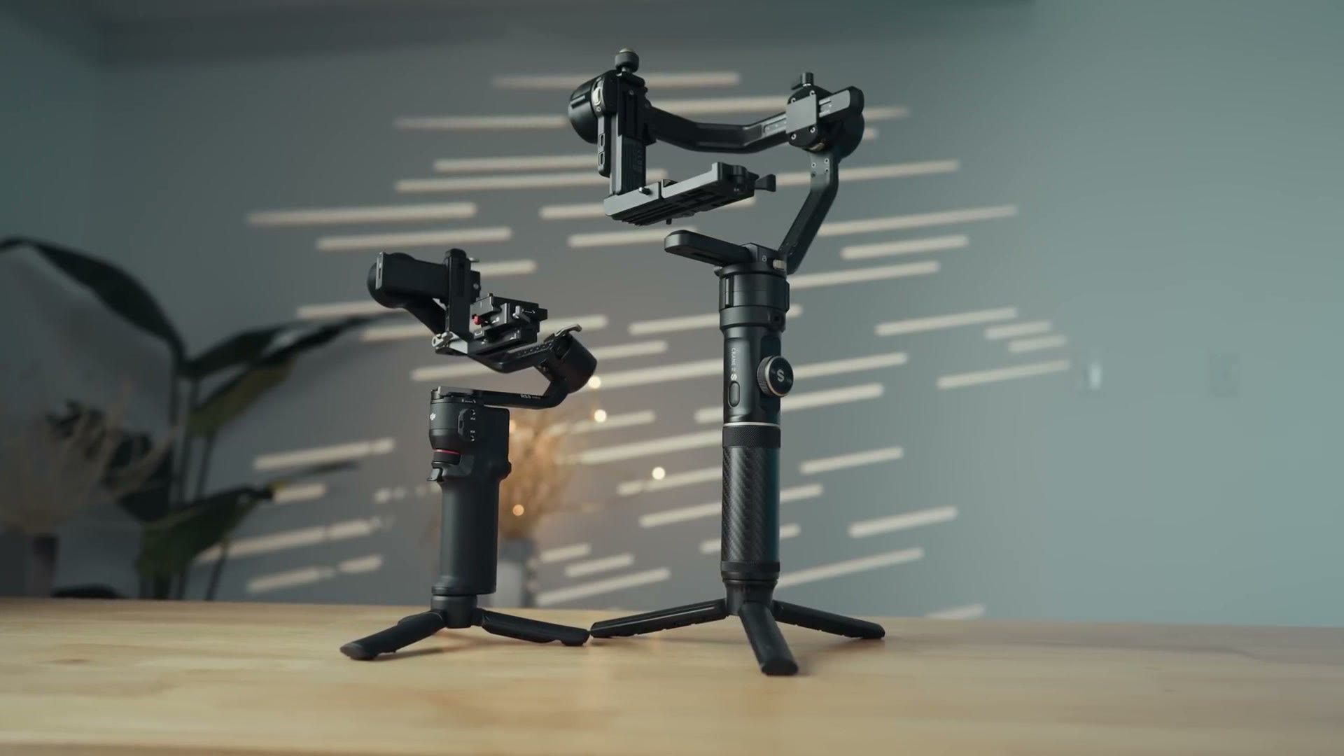 DJI RS 3 gimbal standing on a table with its tripod legs extended